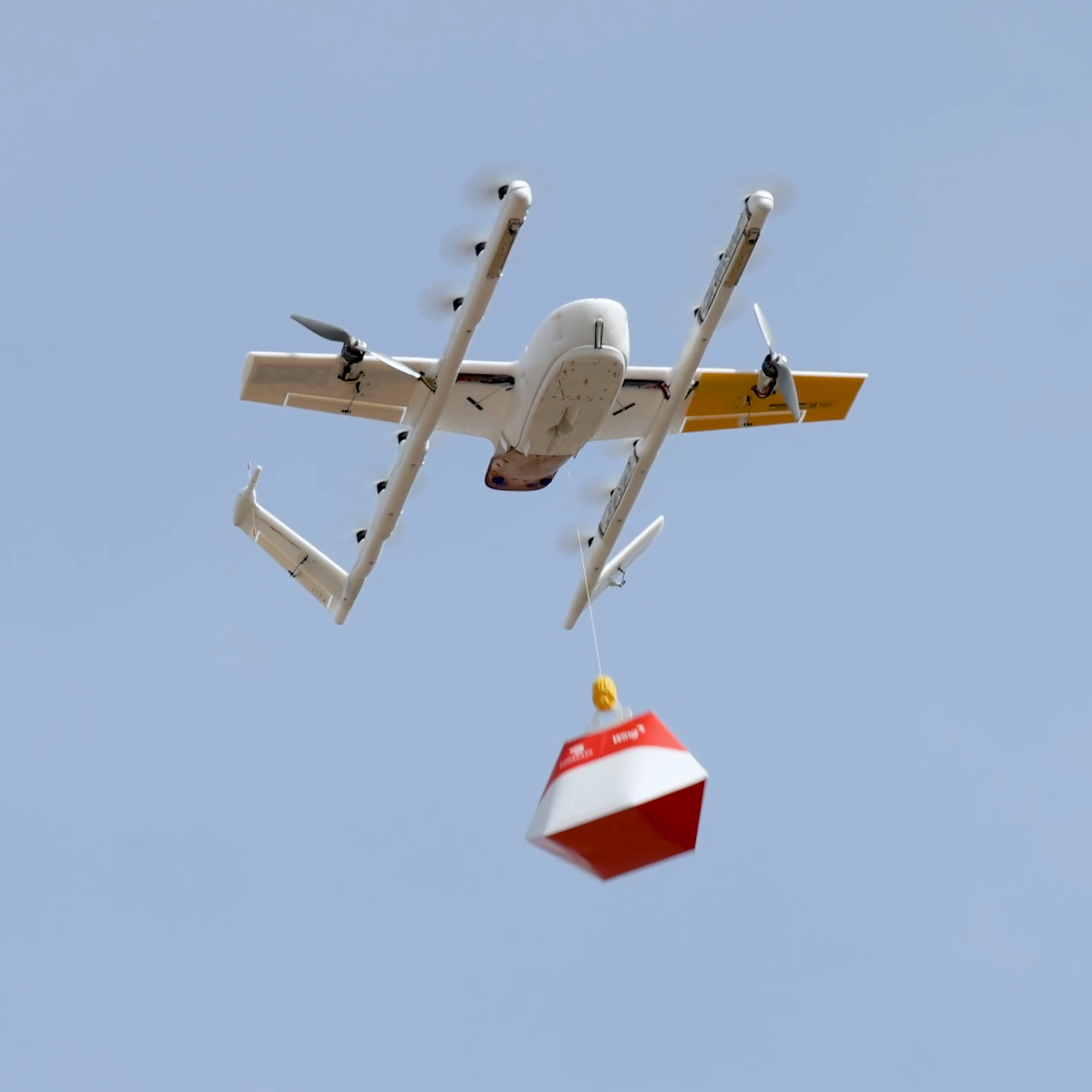 A picture of a Wing drone dropping a DoorDash delivery.