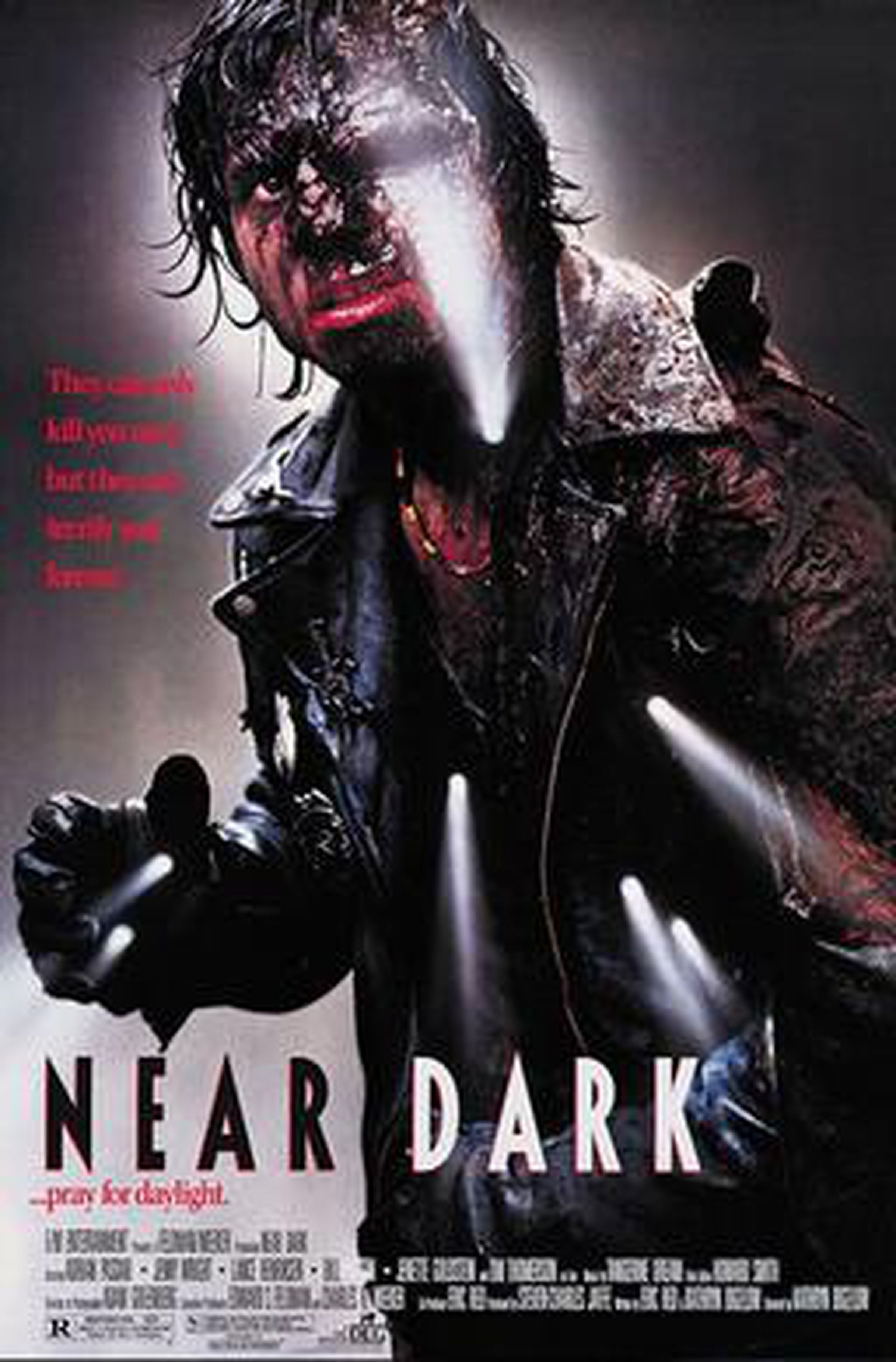 Movie poster for Near Dark, showing scary man with mangled face