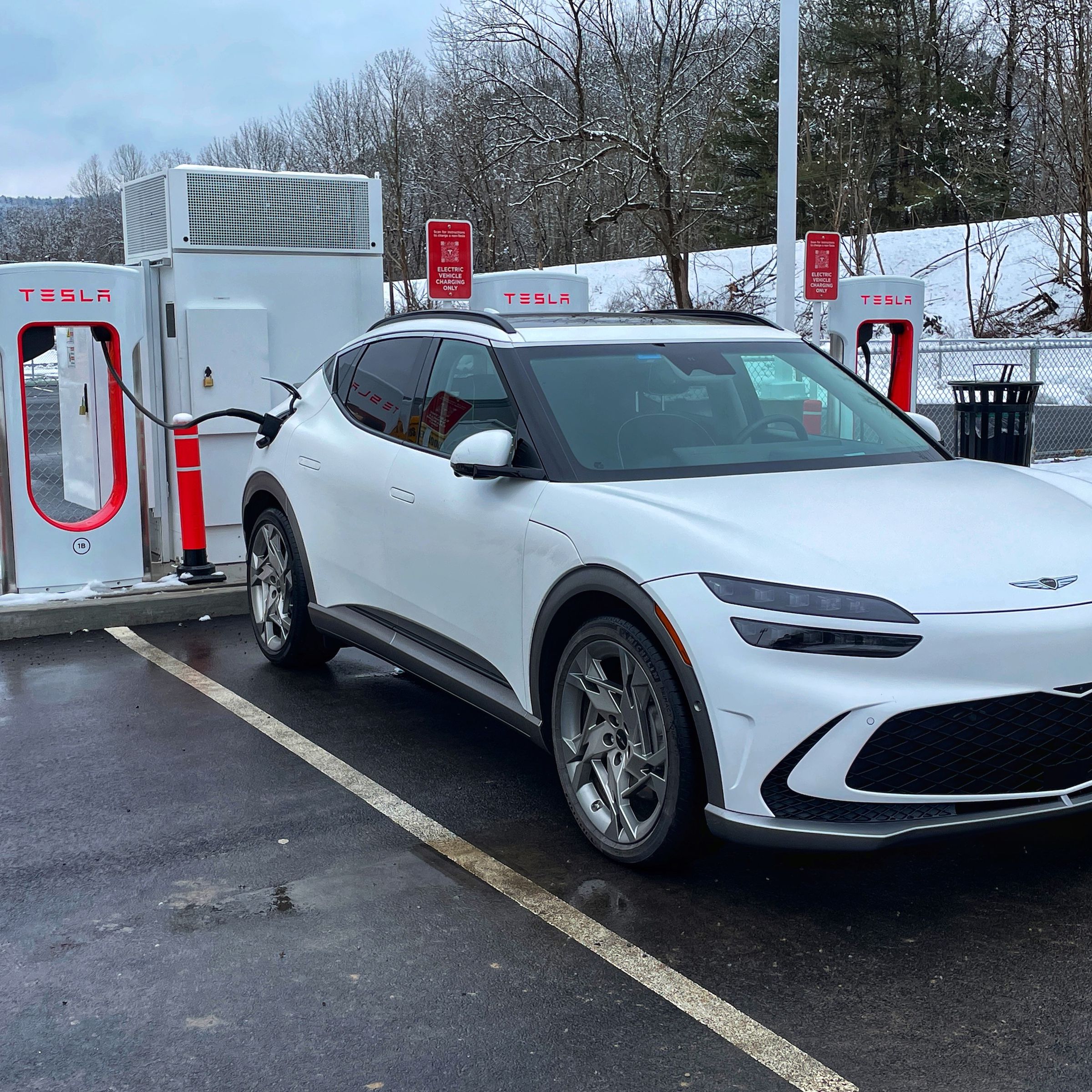 Genesis GV60 charging at a Tesla Supercharger