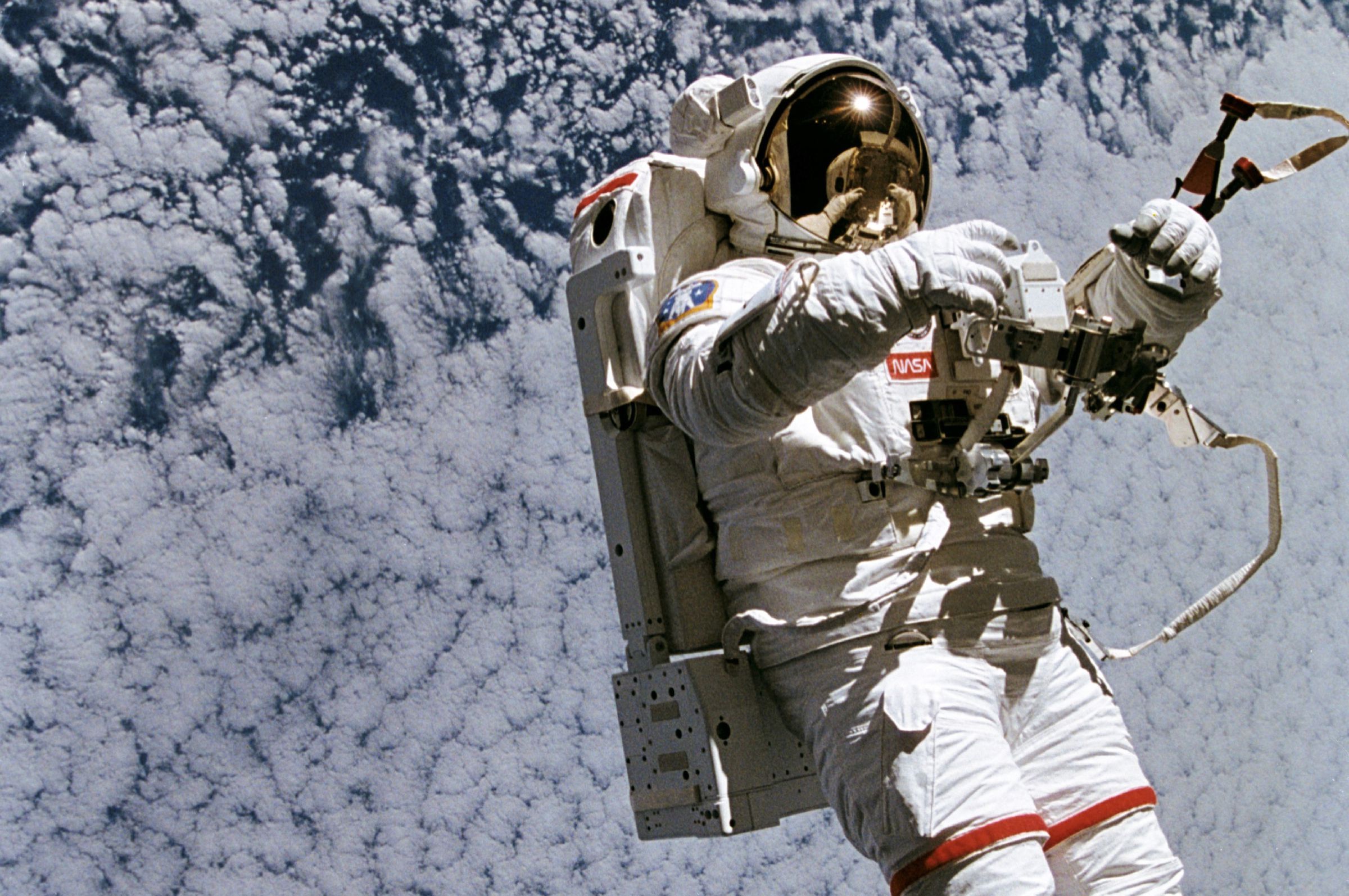 A NASA astronaut wearing the SAFER jet backpack during a spacewalk.