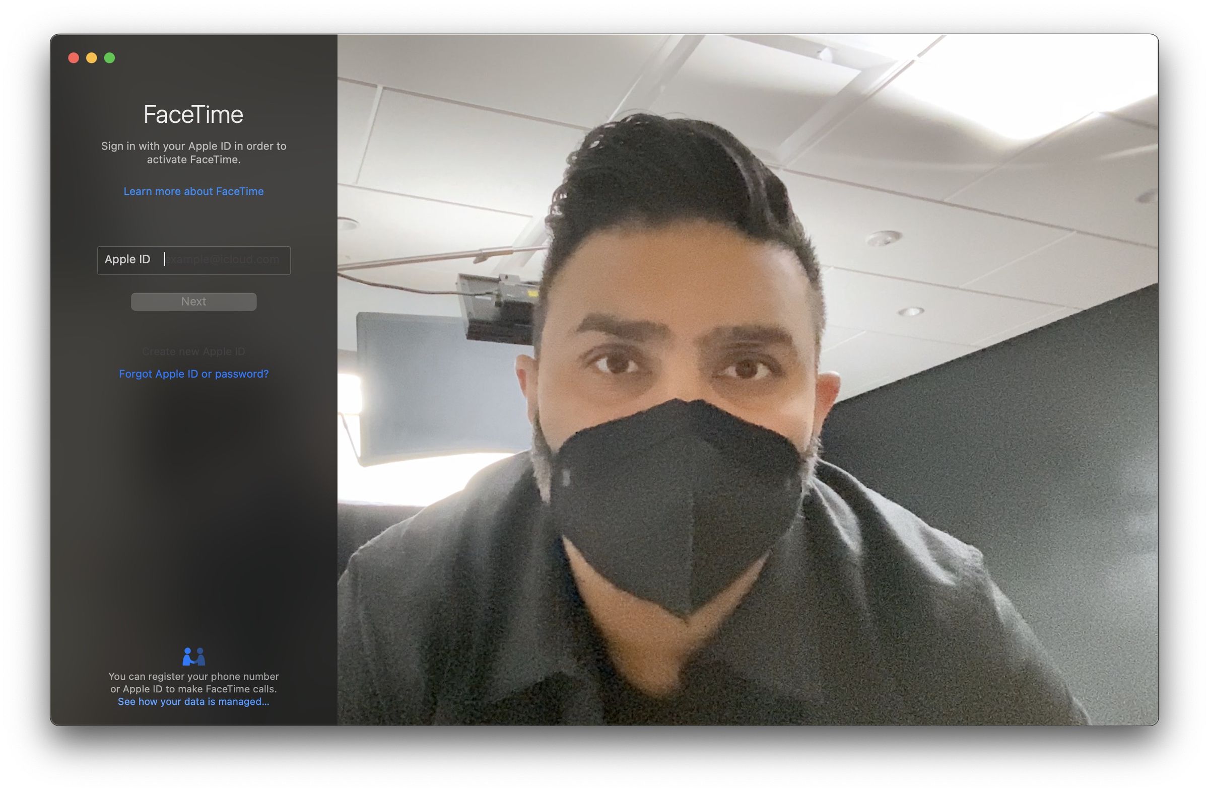 Apple Studio Display webcam screenshot in a studio, wearing a mask