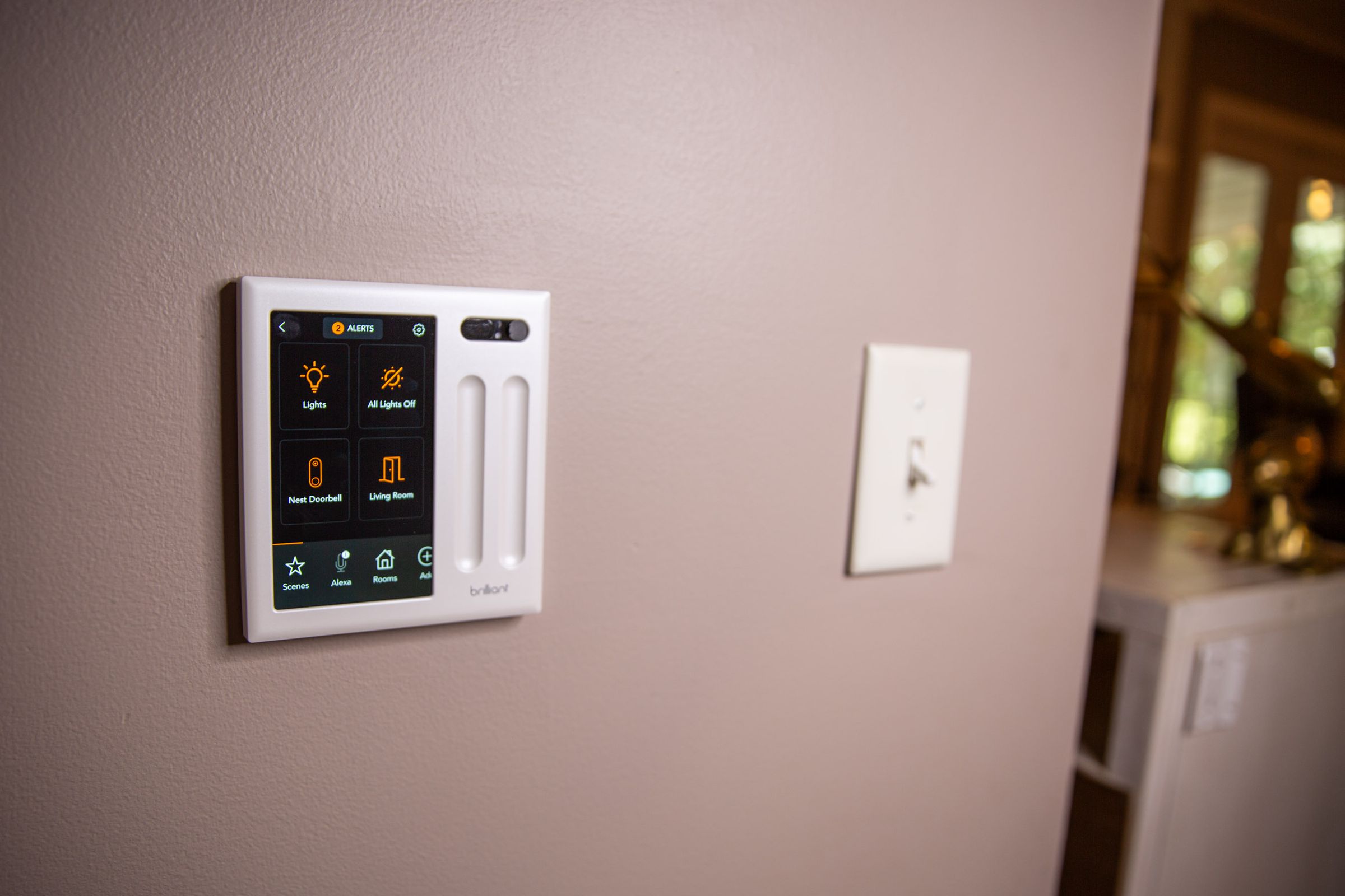 The Brilliant Smart Home Controller (left) paired a touchscreen panel with a physical dimmer switch for controlling hardwired lights. 