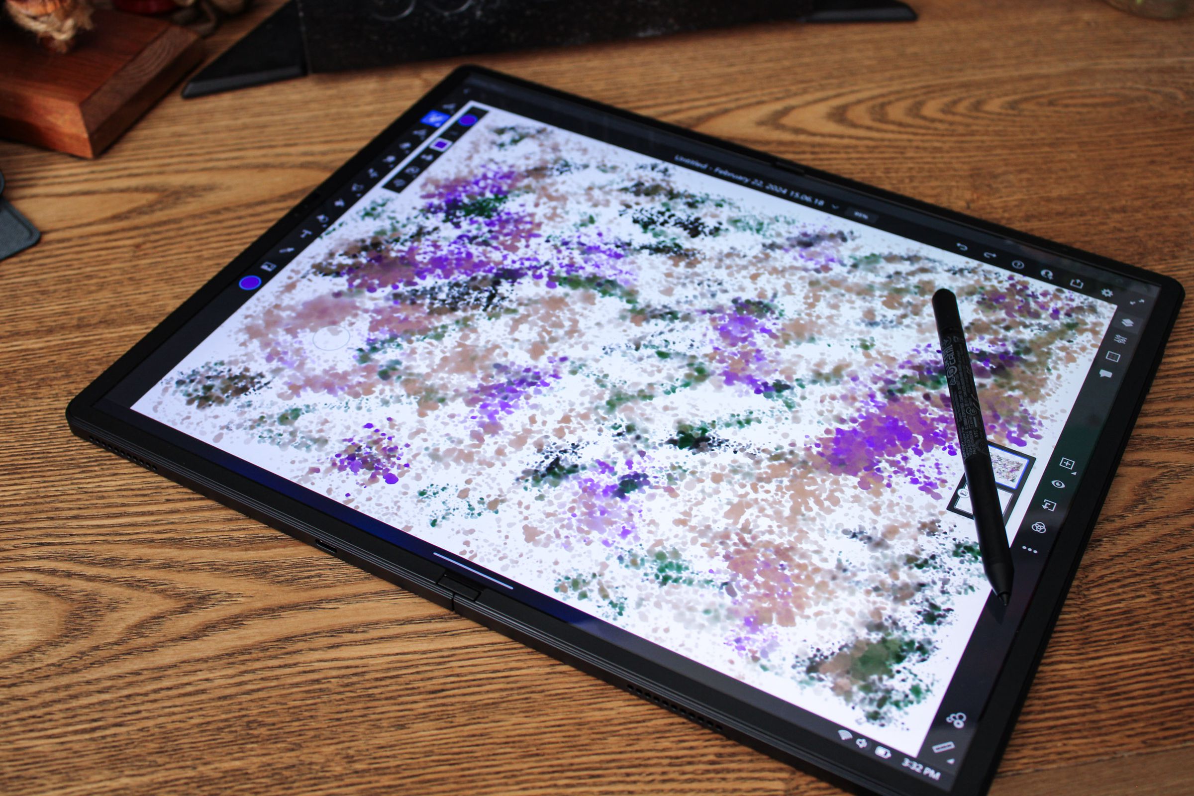 A large drawing tablet showing splotches of digital paint in different colors.