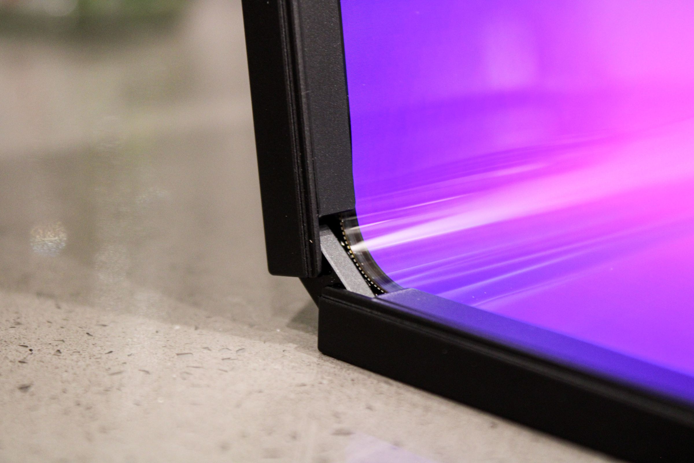 A close-up showing the rounded corner of a foldable laptop display.