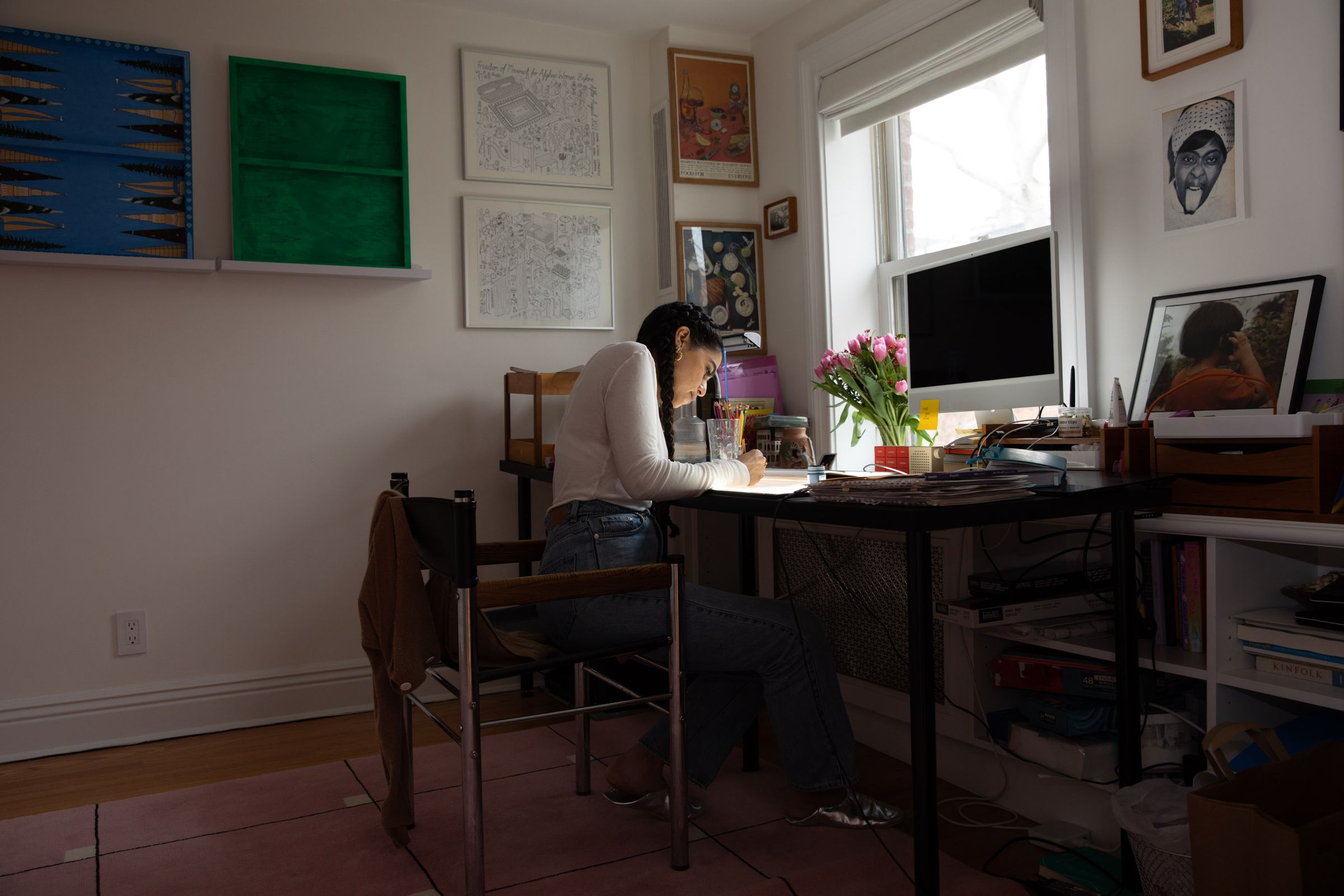 Photo of Chalabi working at her desk. 