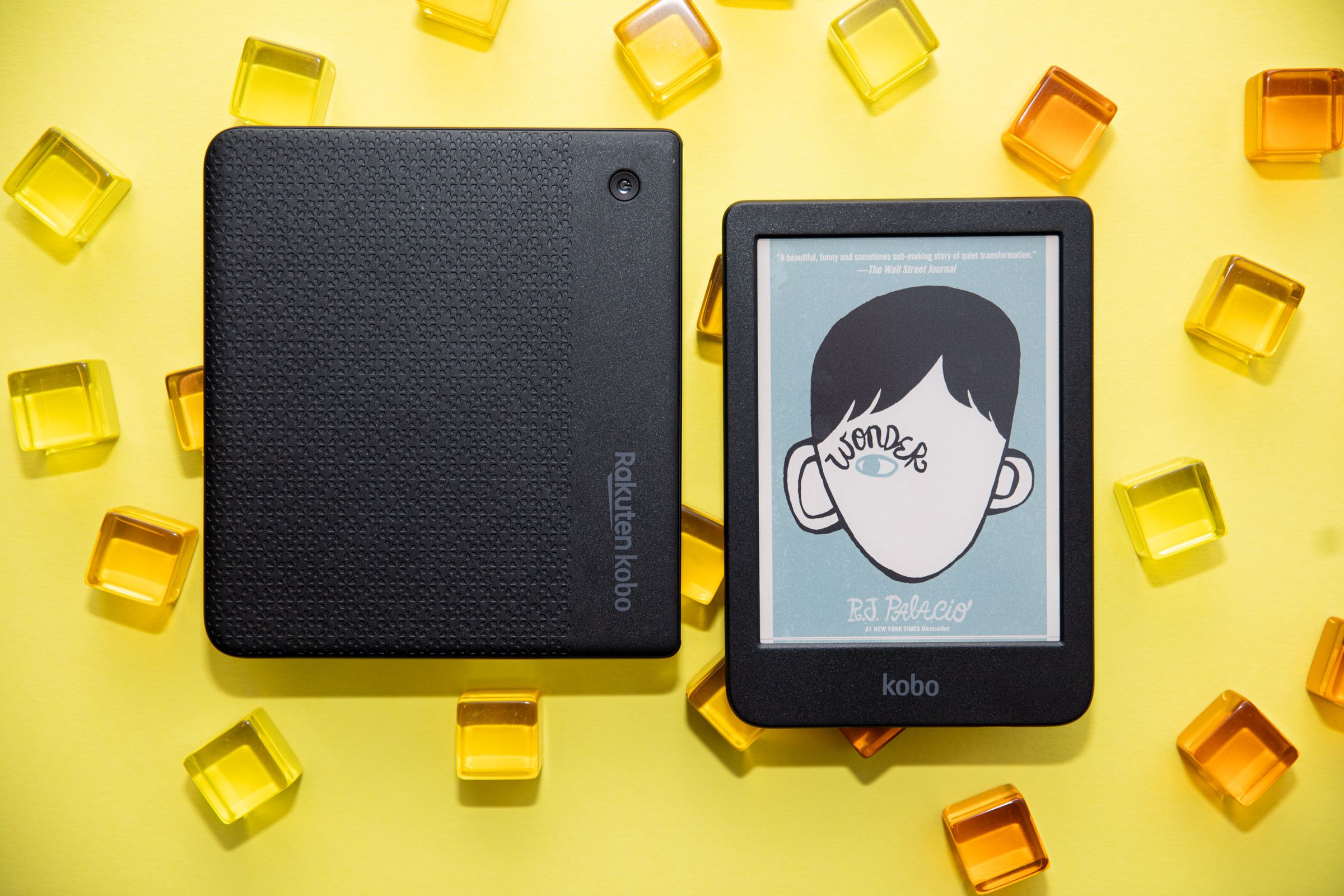 An image of two ereaders on a vibrant yellow background. The color displays appears less vibrant.