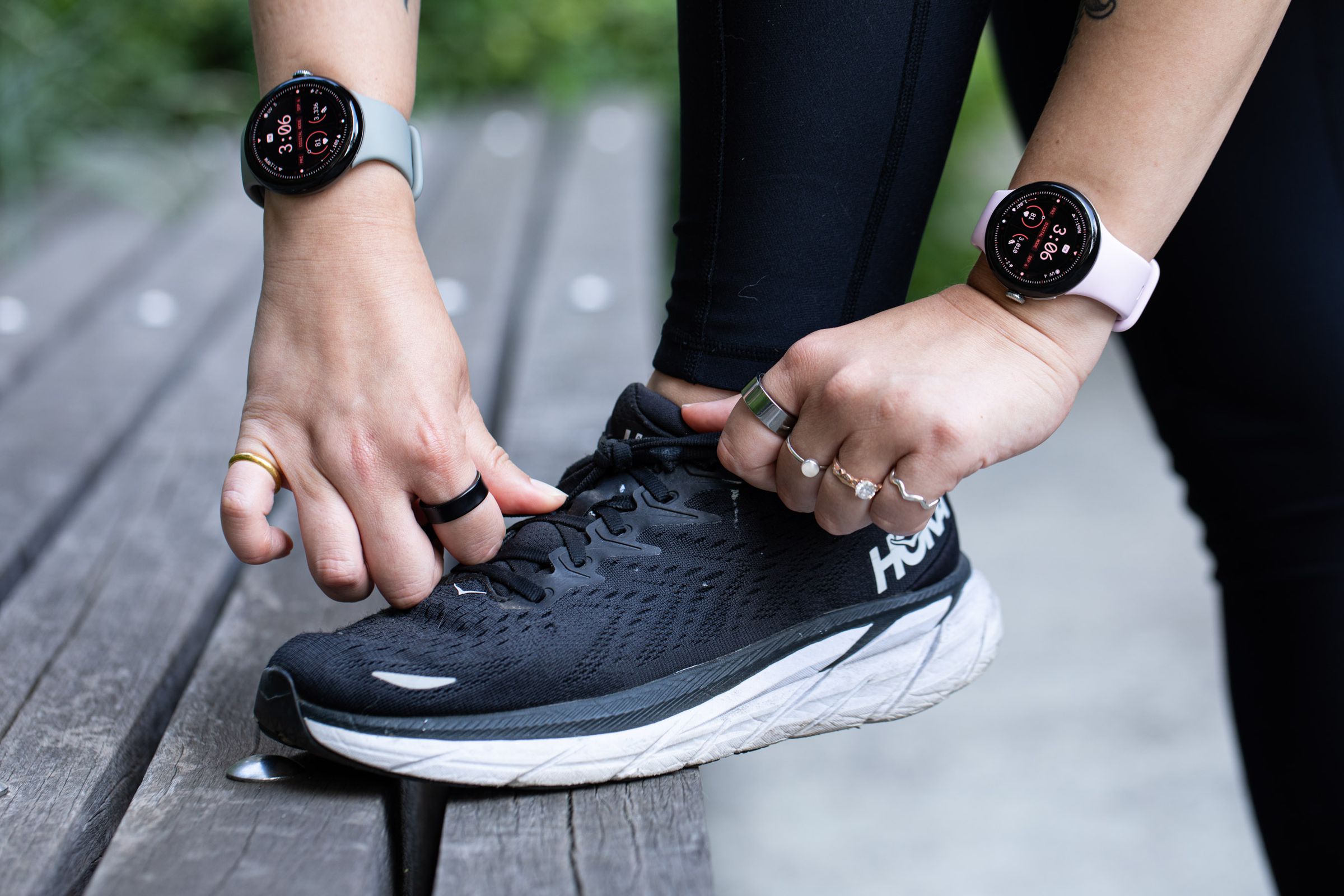 Person tying shoes while wearing both sizes of the Pixel Watch 3