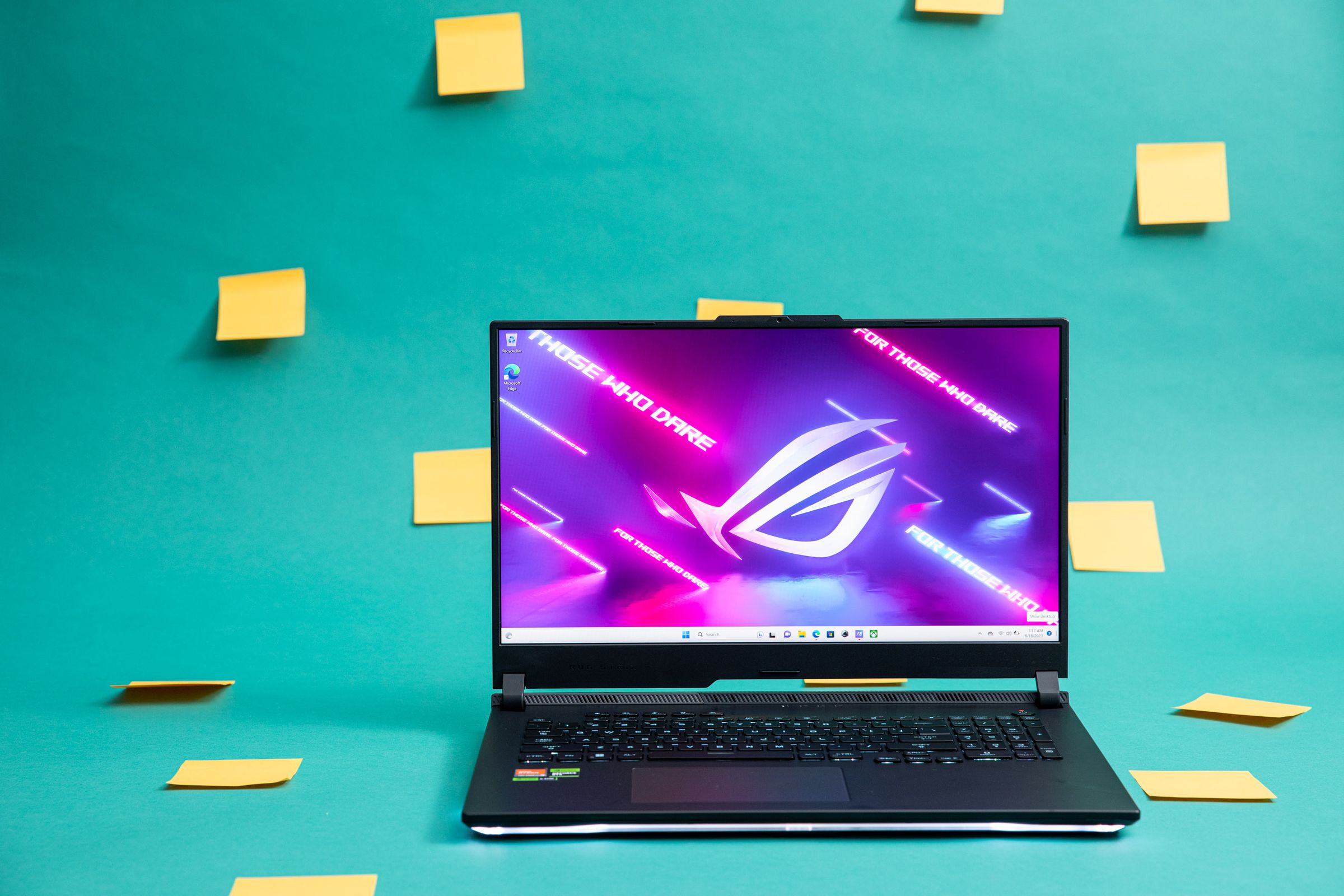 The Asus ROG Strix Scar X3D on a green background decorated with yellow Post-it notes.
