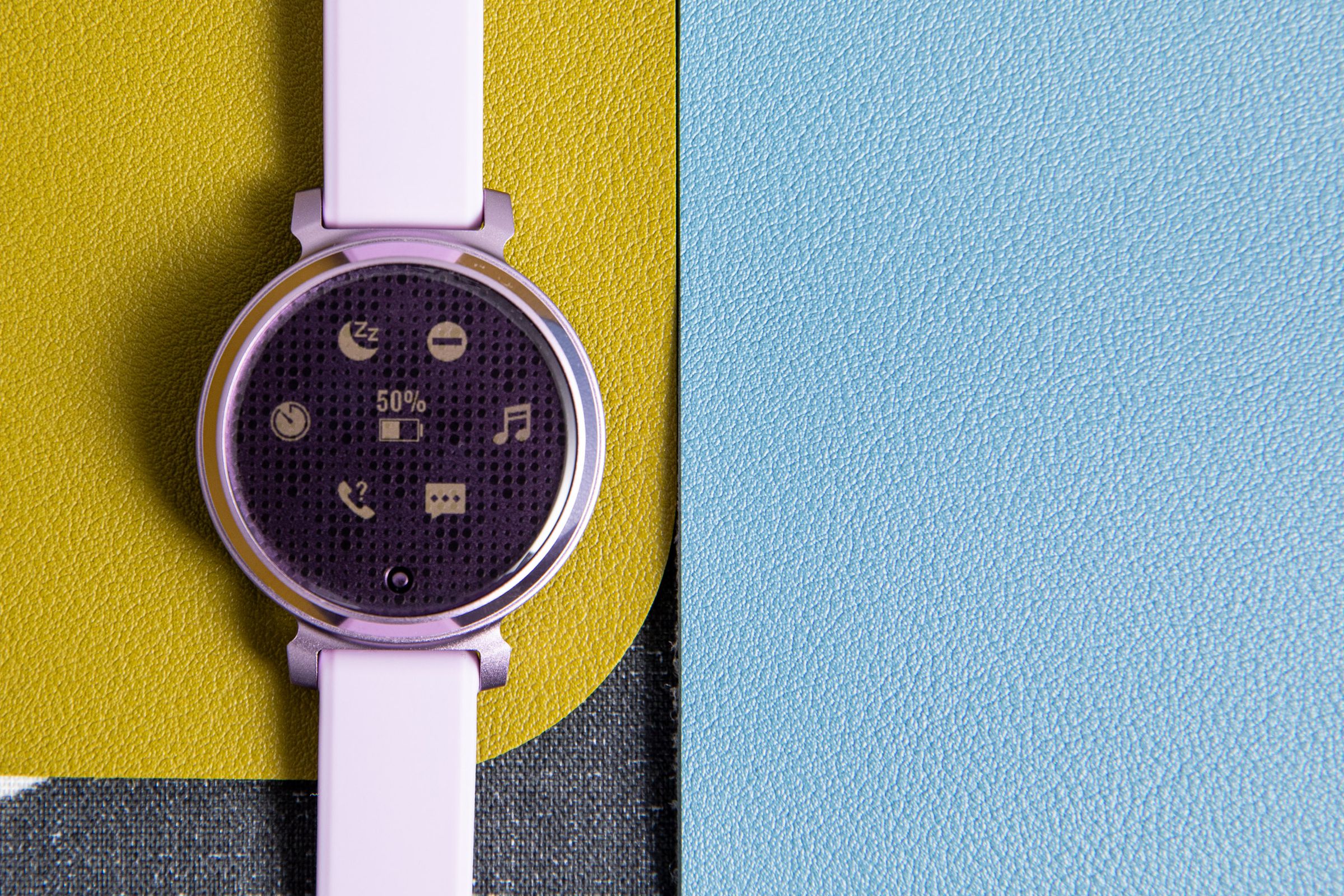 close up of lilac Garmin Lily 2 Sport on a colorful background