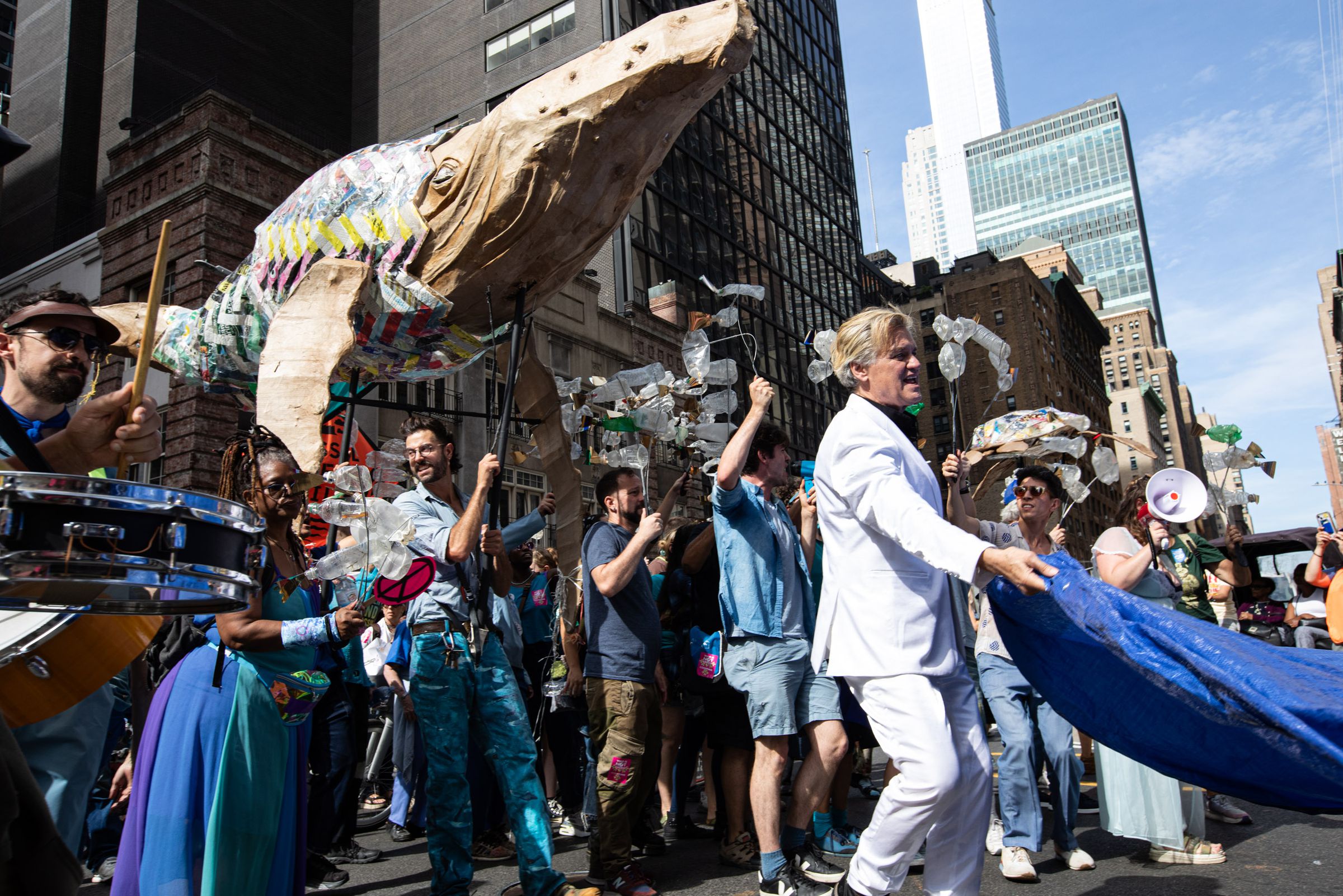 Activist Reverend Billy in front of a group of puppeteers from Bread and Puppet Theatre at the March to End Fossil Fuels. 