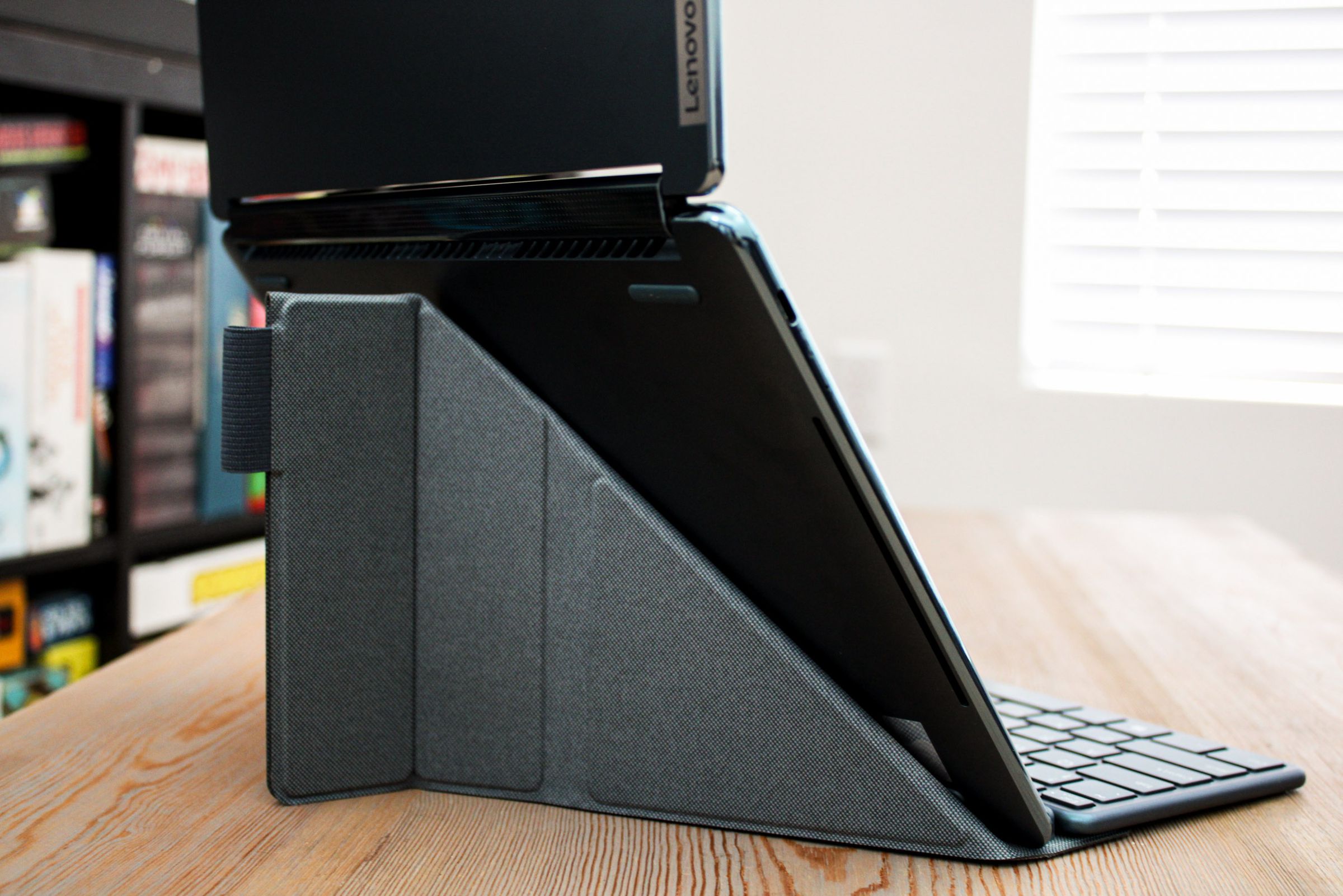 The back of a laptop propped up by a stand.