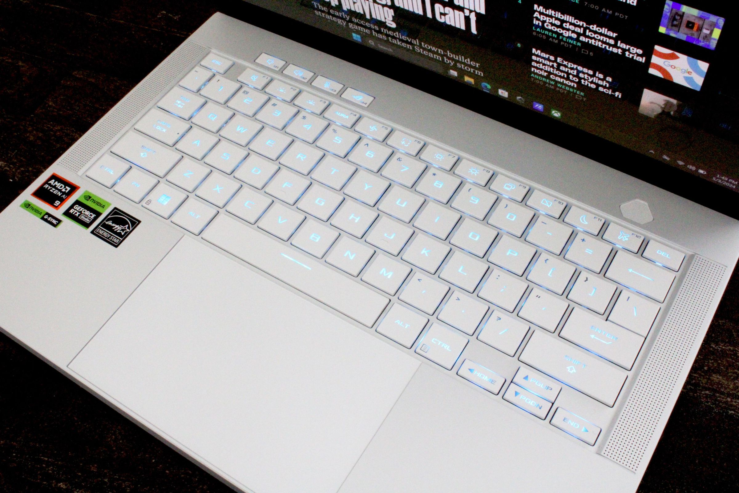 A close-up of a laptop keyboard with white keys and a white chassis.