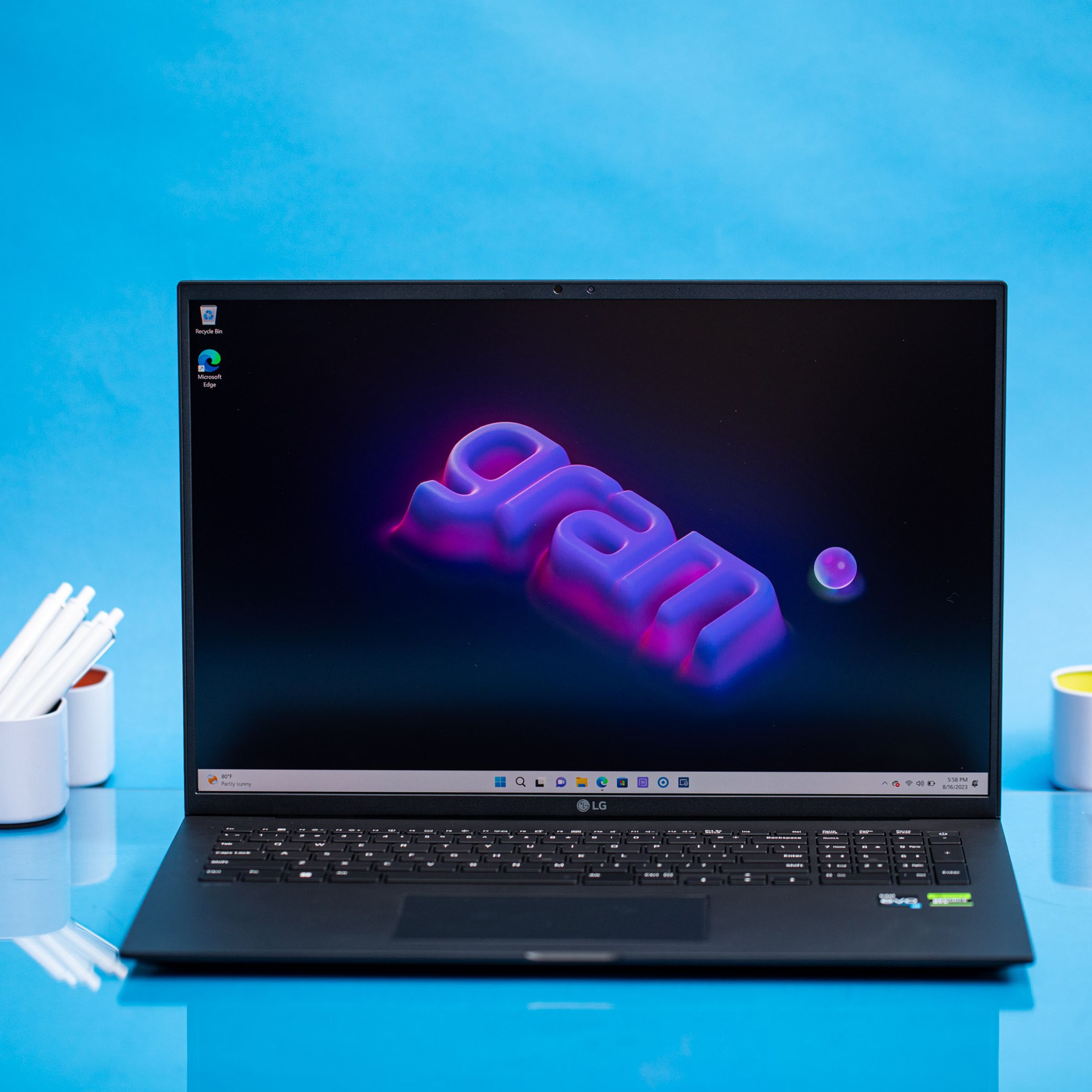 The LG Gram Pro 17 displaying a desktop background that has the Gram logo written in purple and pink.