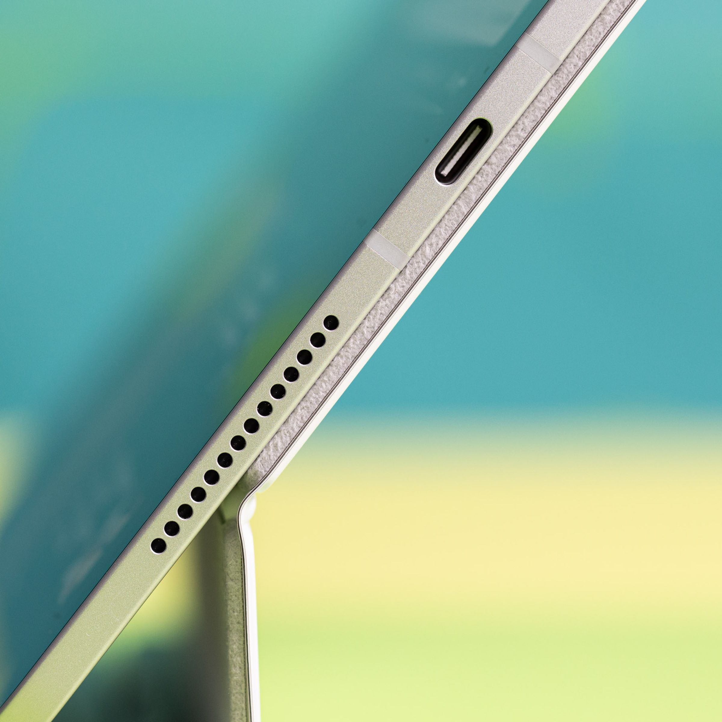 A photo of the edge of an iPad Pro, showing the speaker and USB-C port.