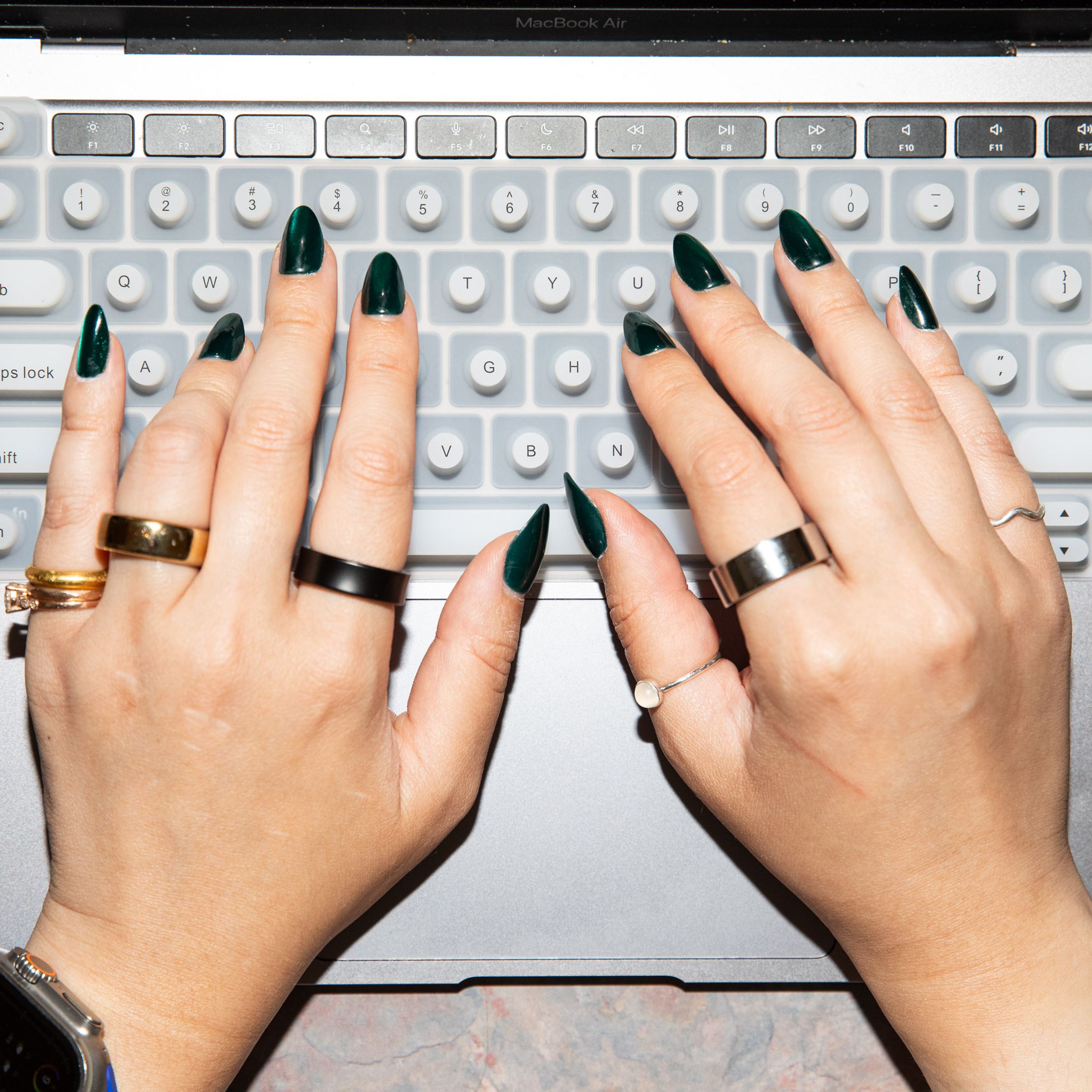 Person with long nails using the Tippy Type keyboard cover