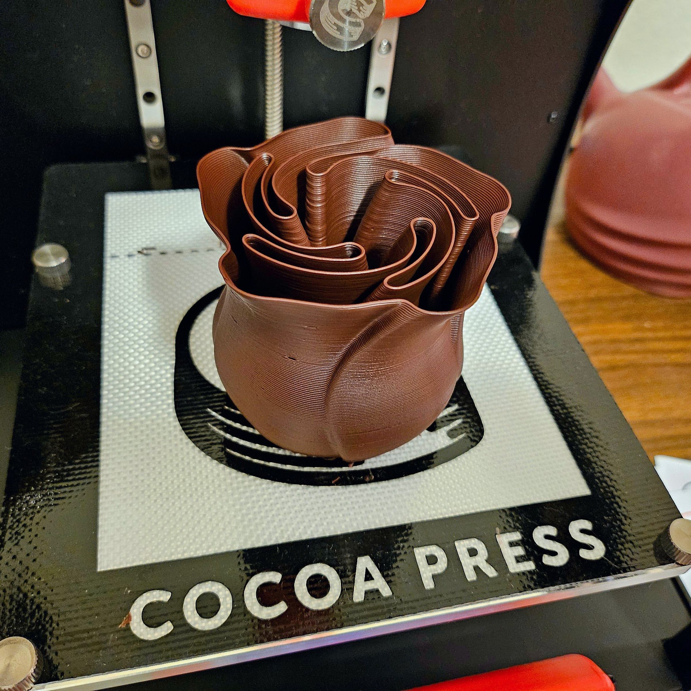 A chocolate rose printed on the Cocoa Press.
