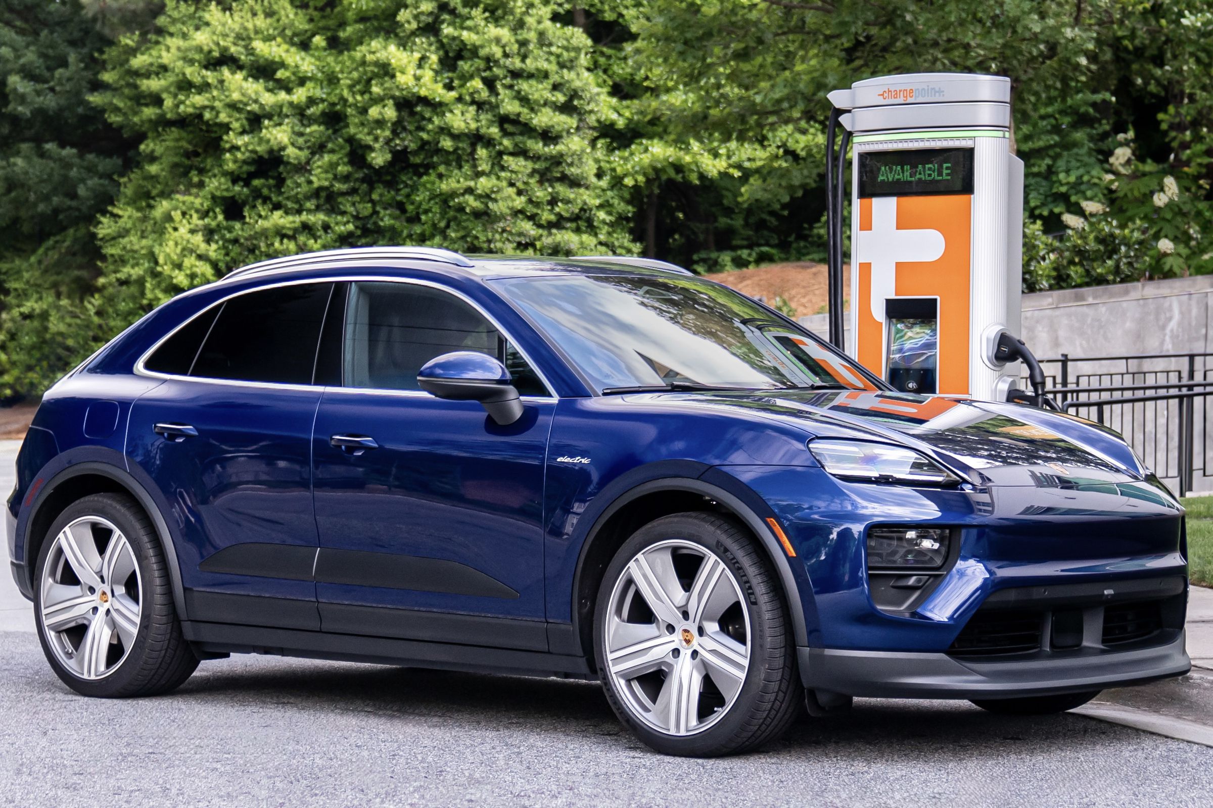 blue suv in front of orange charging stall