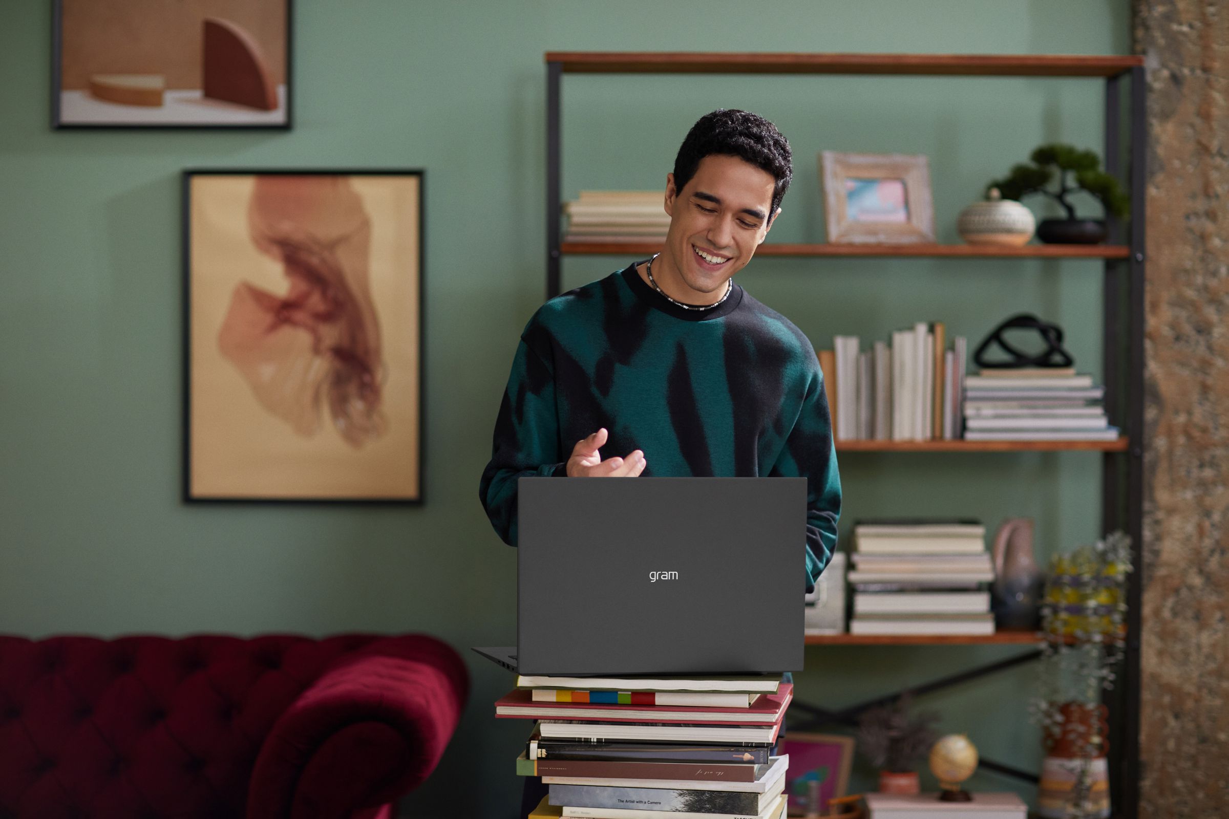 A user video chats on an LG Gram laptop with a bookshelf in the background.