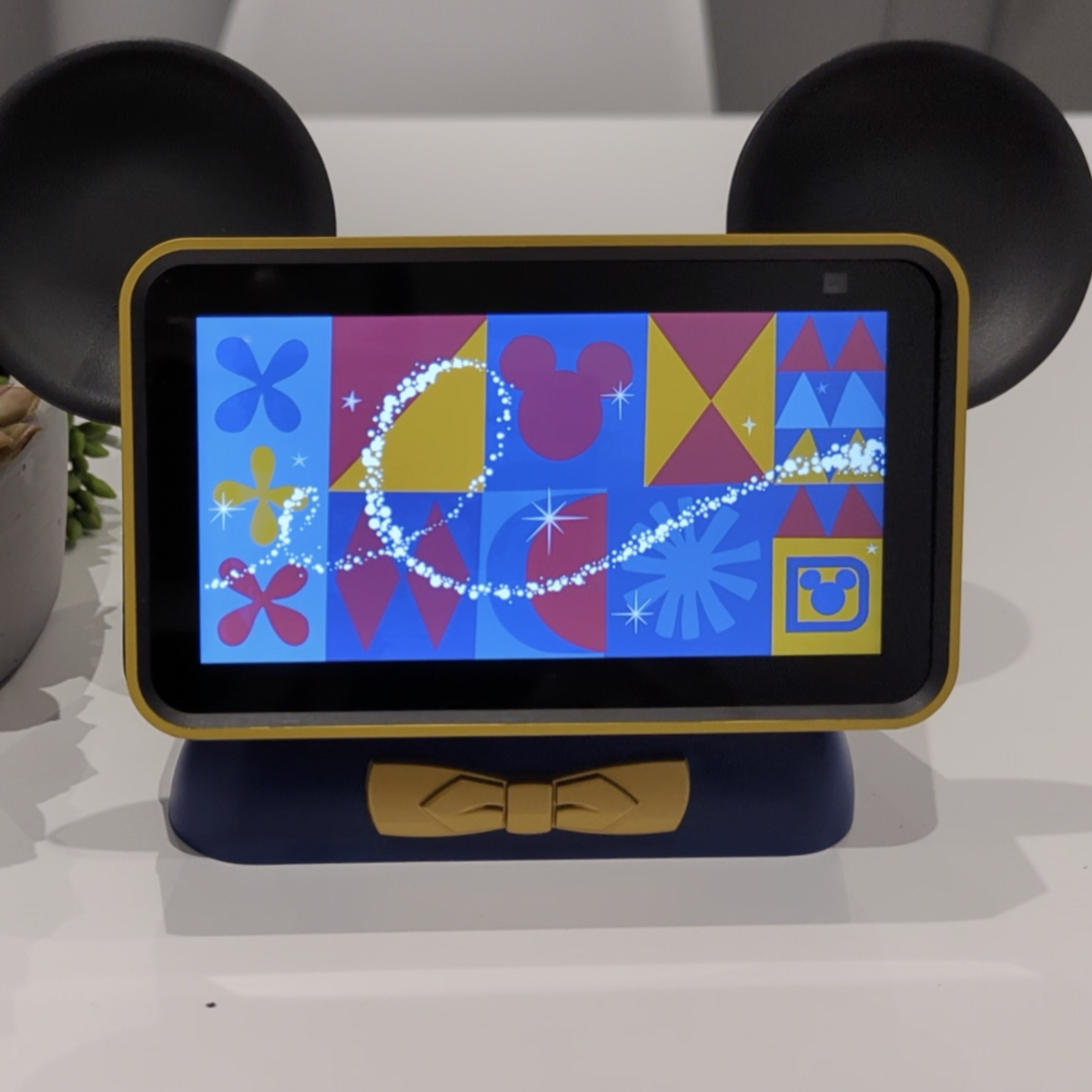 Photo shows a smart display with Mickey Mouse ears sitting on a table, waiting to respond to the “Hey Disney!” command.
