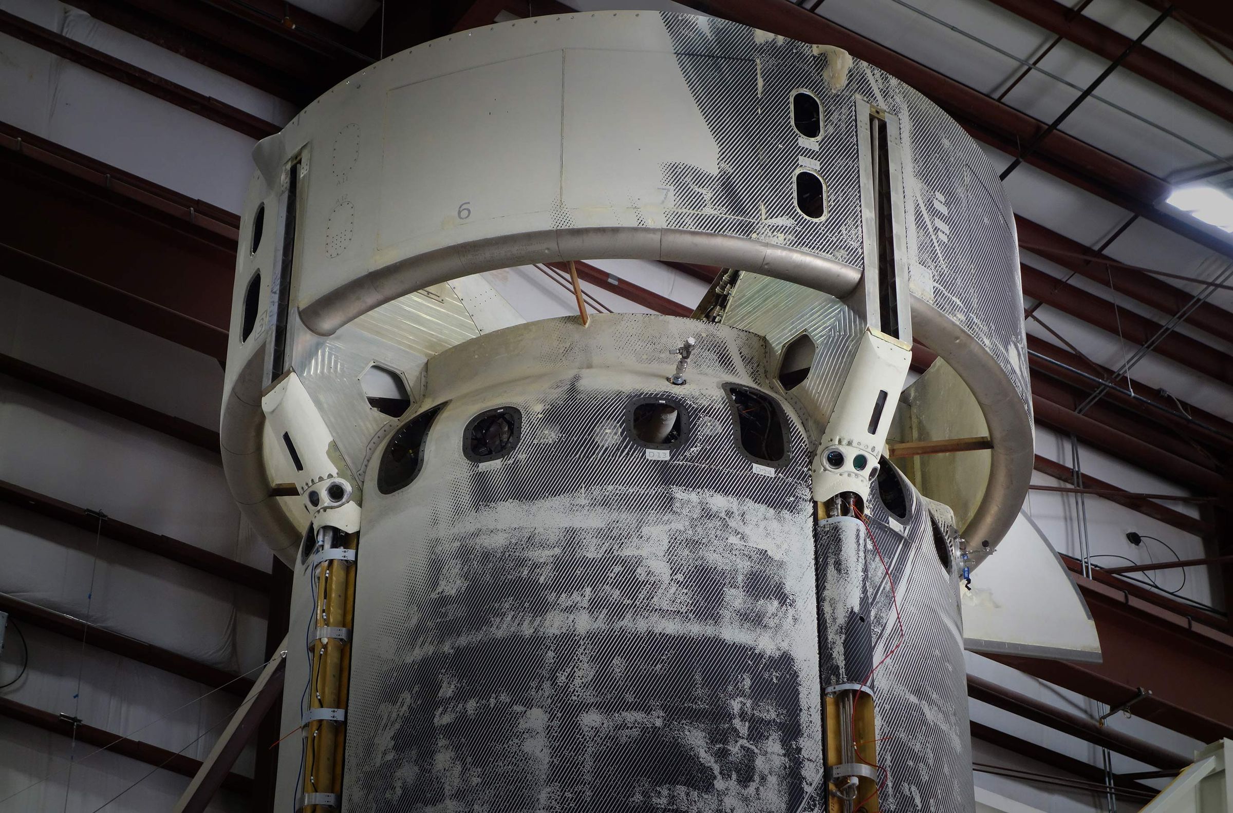 The New Shepard rocket with NASA’s SPLICE experiment mounted on the outside. Two white sensor packages are attached to the bottom of the ring fin.