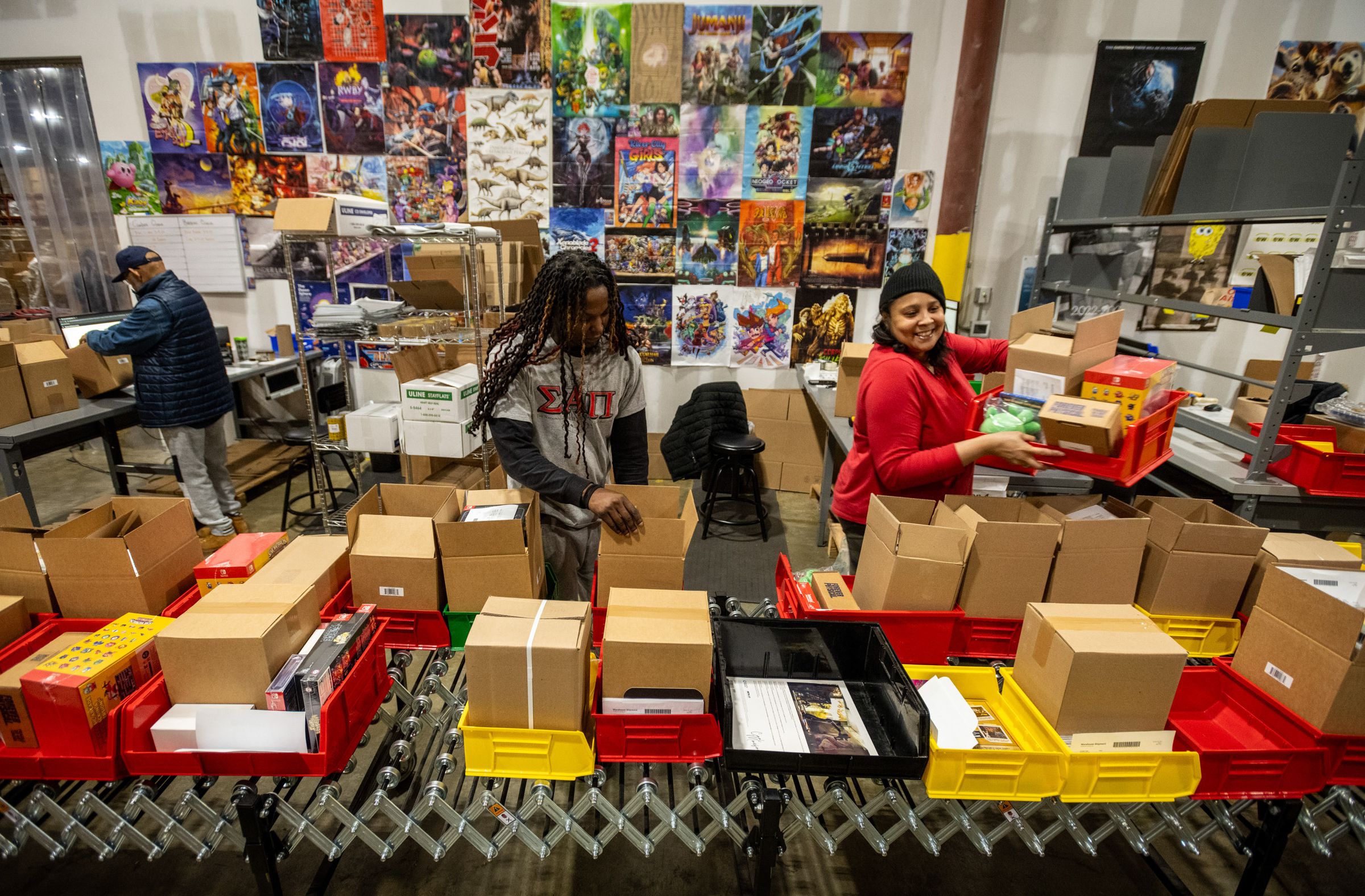 Bobby Spidey (left) and Yvette Holmes are packing games to ship out at the Limited Run Games warehouse in Apex, NC.