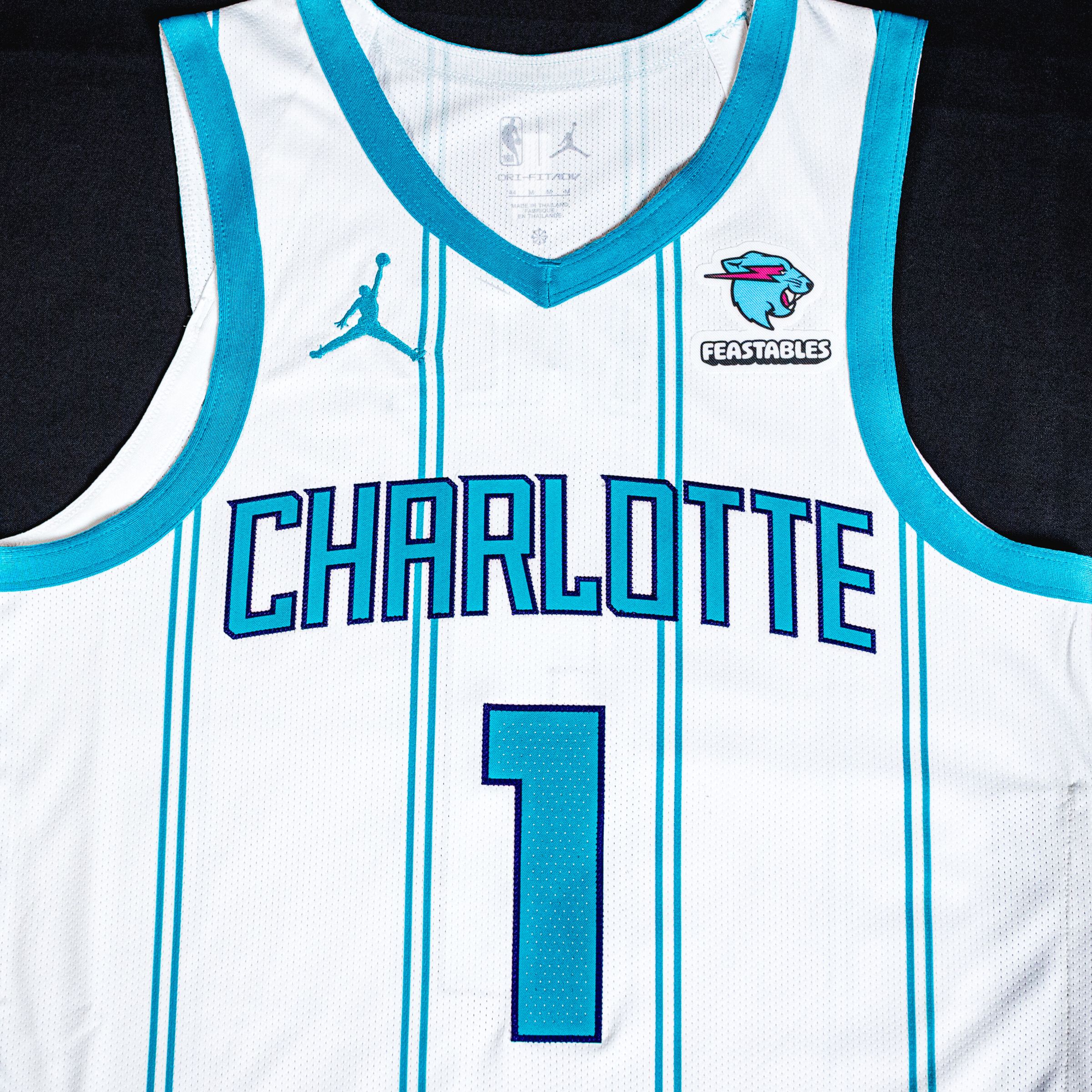 A photo of the Feastables logo on a Charlotte Hornets jersey