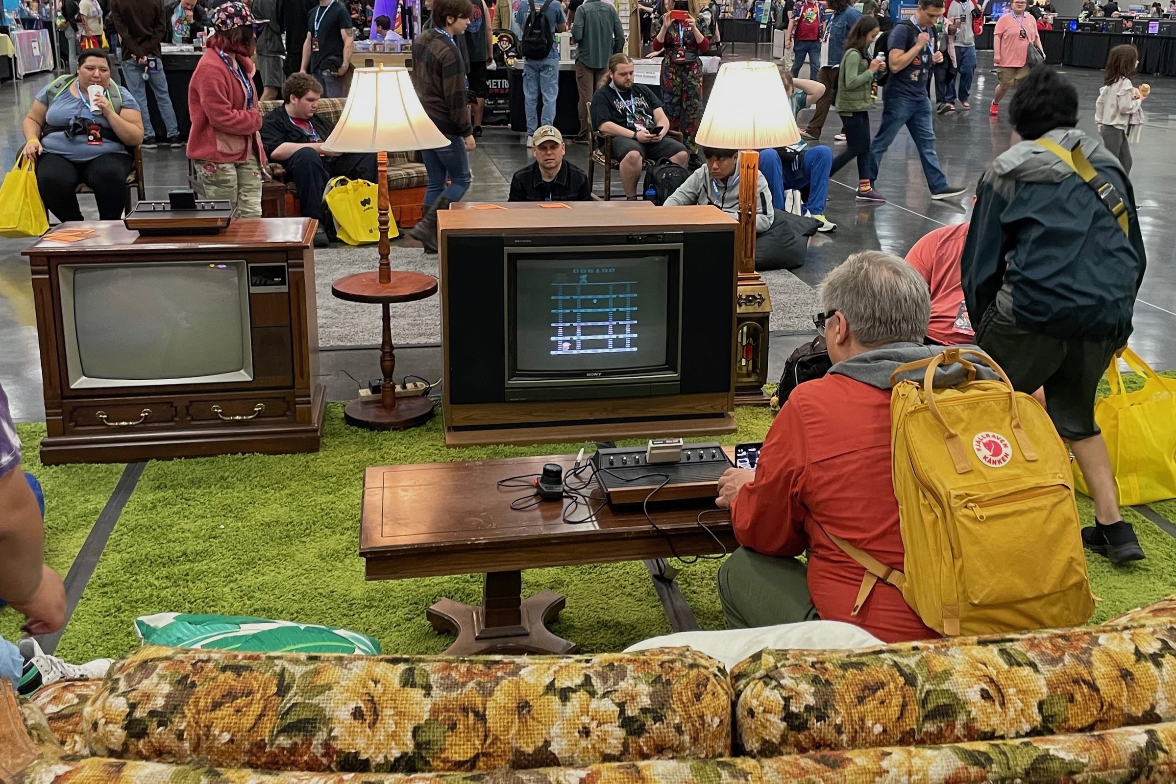 A person sitting on a couch playing an older game at the Portland Retro Gaming Expo.