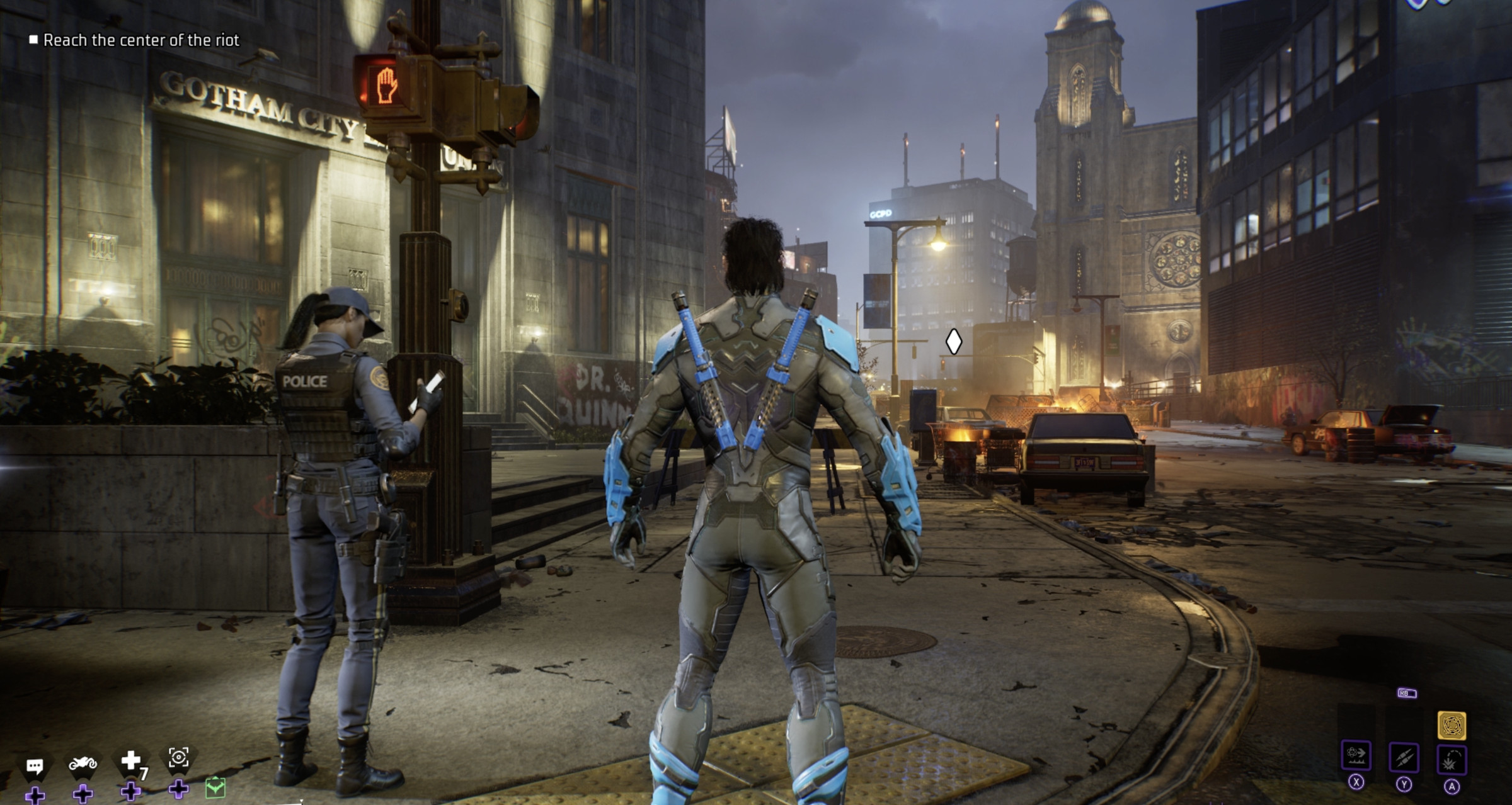 Screenshot from Gotham Knights featuring Nightwing wearing black and blue tactical armor standing next to Gotham Police officer Rene Montoya