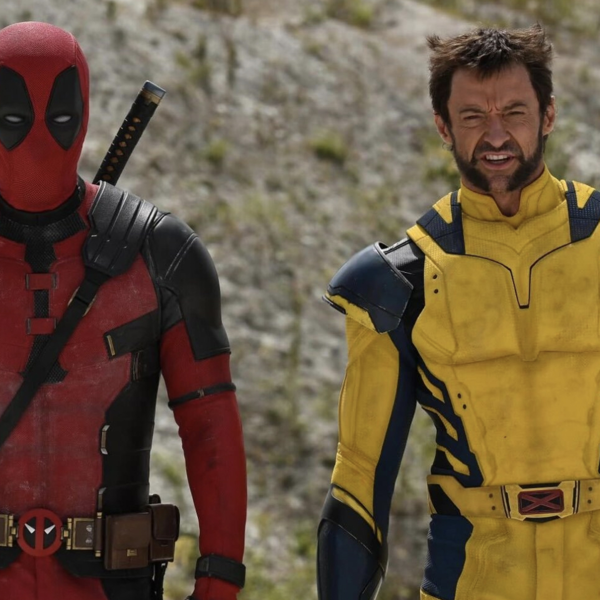 Deadpool on set next to Wolverine in costume.