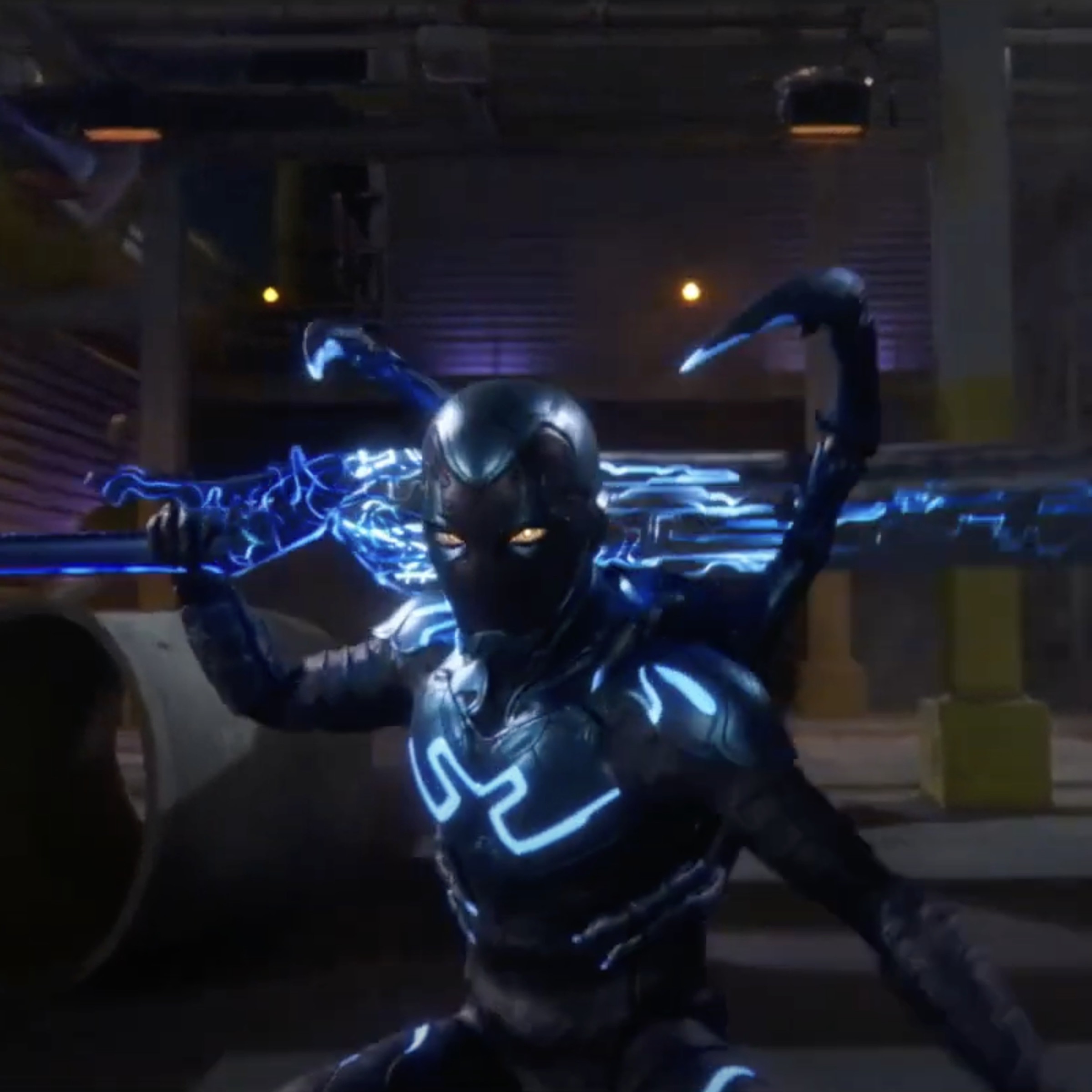 Screenshot from DC Blue Beetle trailer featuring Jaime Reyes in a blue metallic alien exosuit wielding a large sword