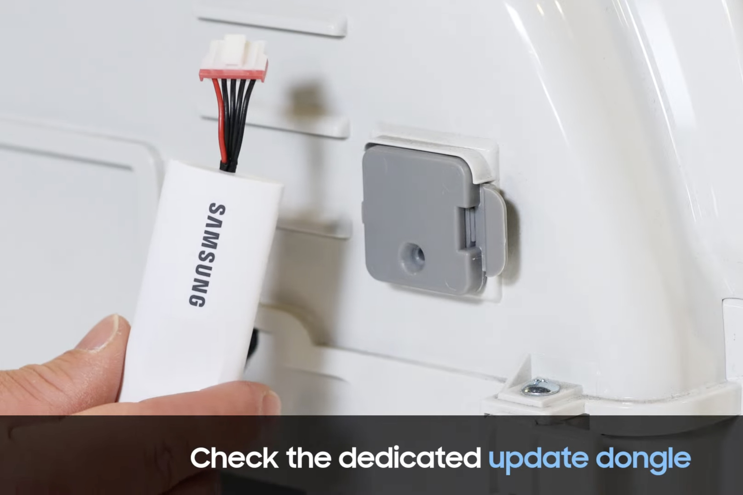 Image of a person holding the Samsung dedicated update dongle.