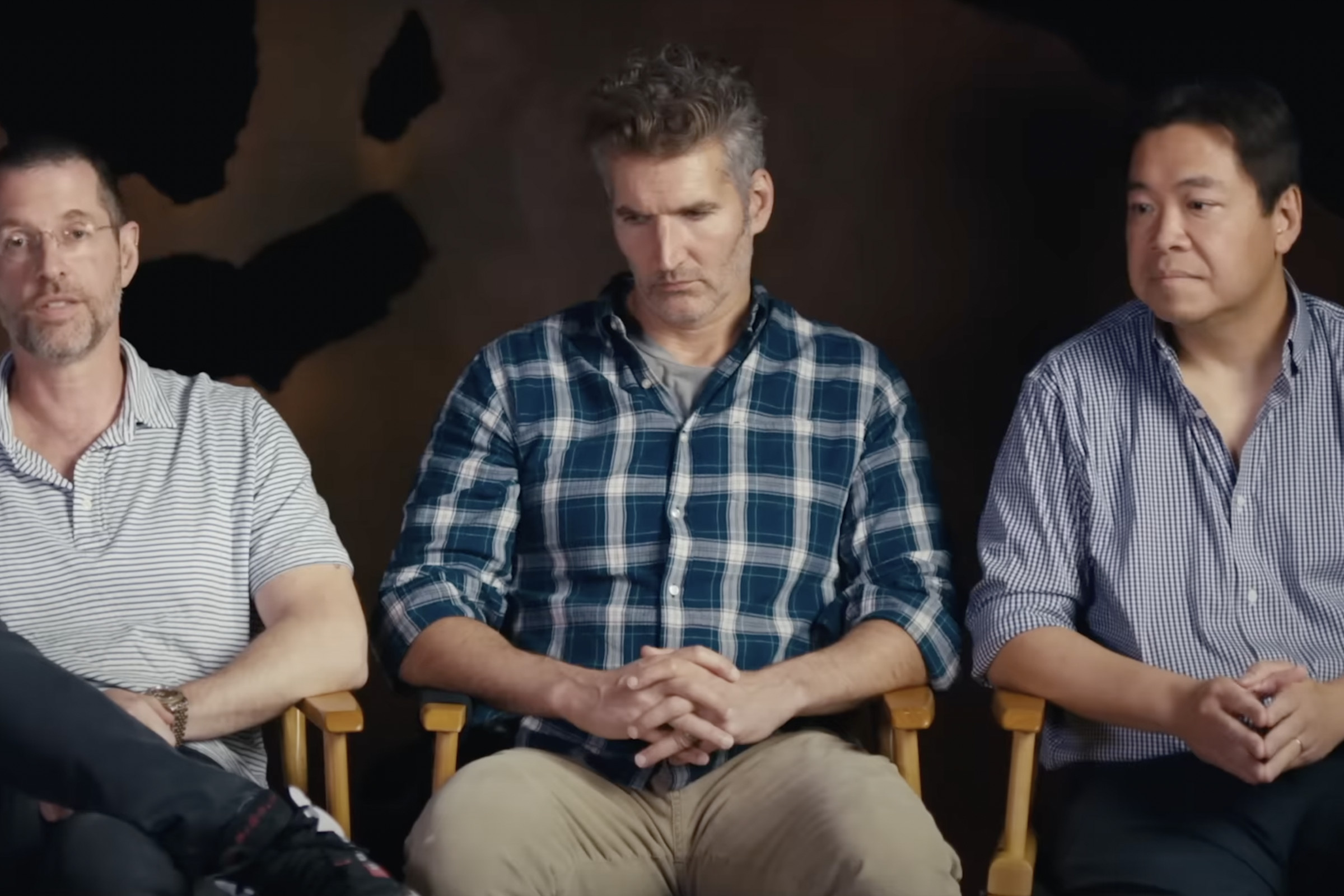 3 Body Problem executive producers D.B. Weiss, David Benioff, and Alexander Woo sitting together in chairs for a promotional video about the upcoming series.