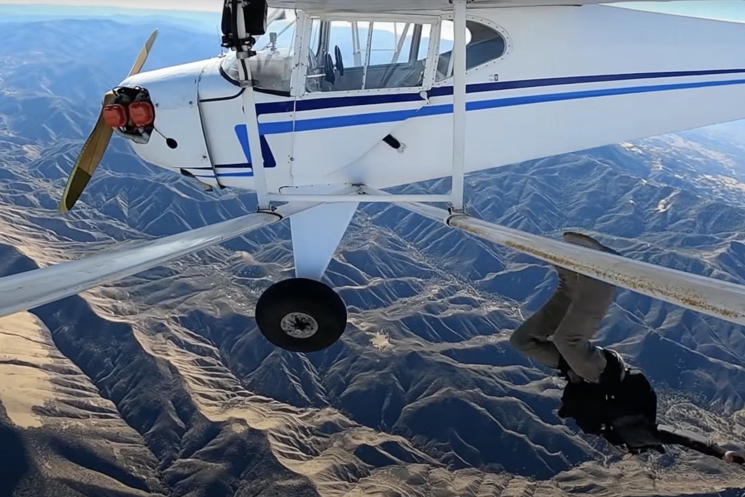 A pilotless plane viewed from the wing in middair. The image is taken from Trevor Daniel Jacob’s YouTube video of him intentionally crashing the plane.