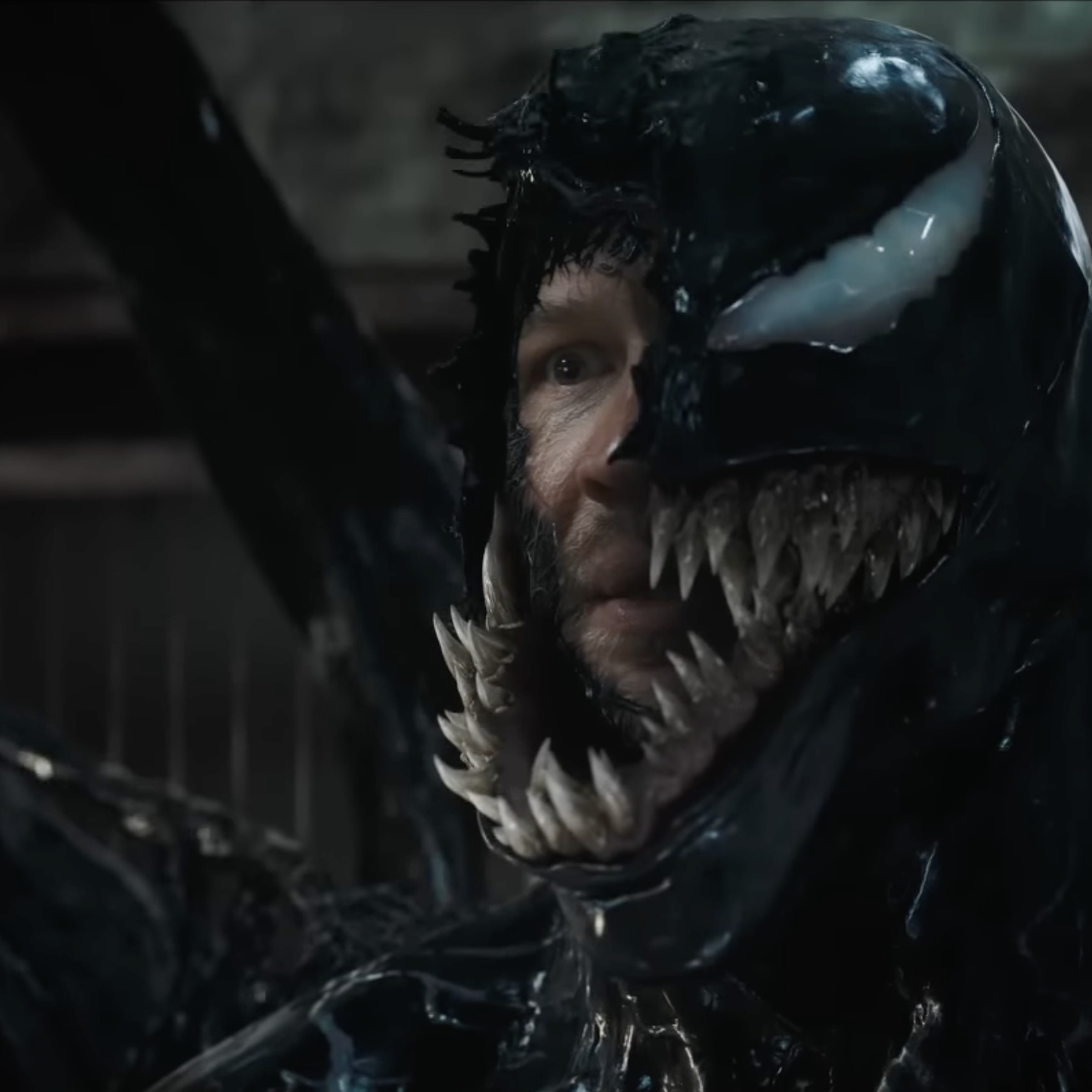 Picture of Venom with part of his mask removed, exposing Eddie Brock’s face.