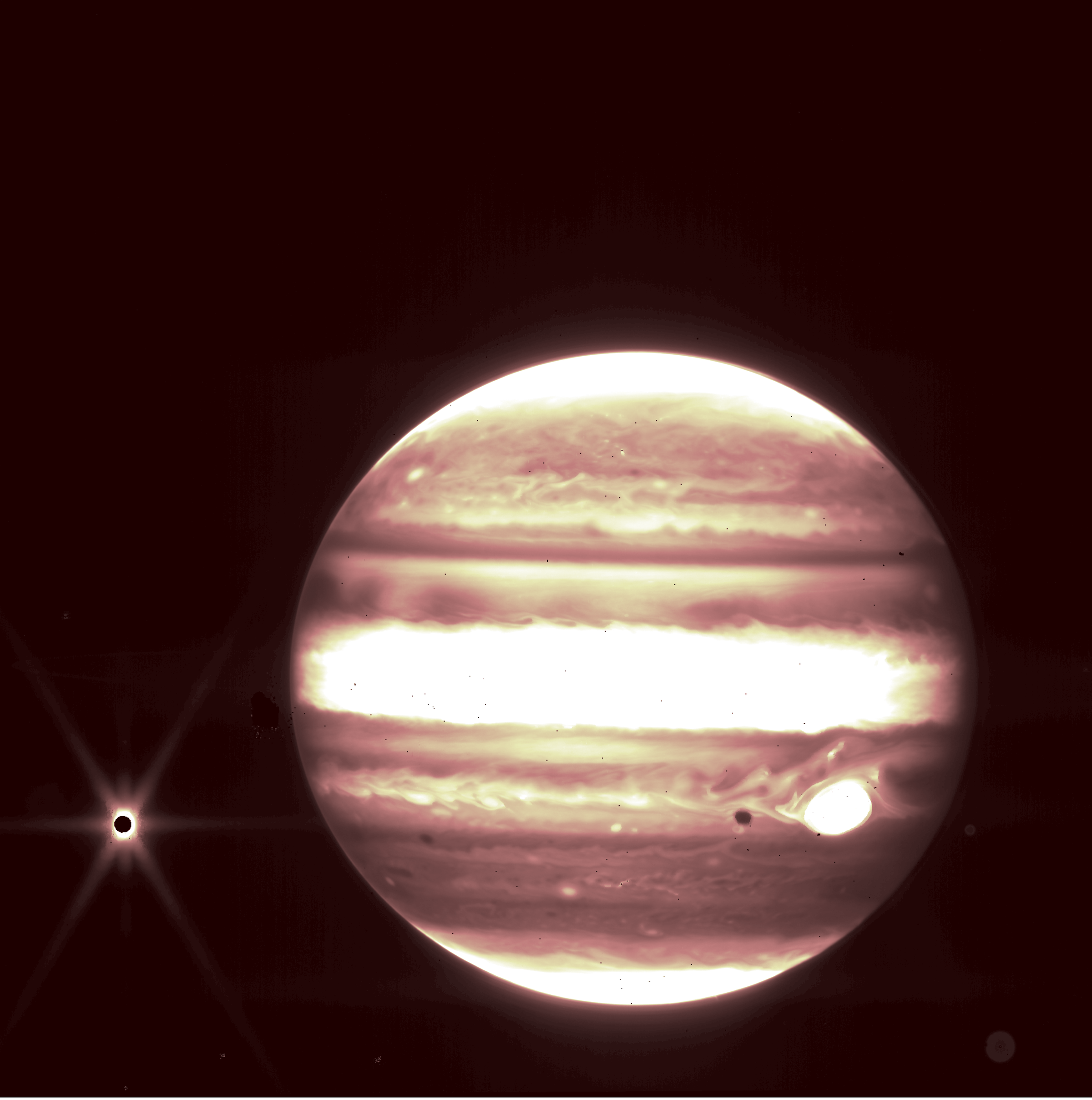 <em>Jupiter and its moon Europa seen through JWST’s NIRCam instrument 2.12 micron filter.</em>