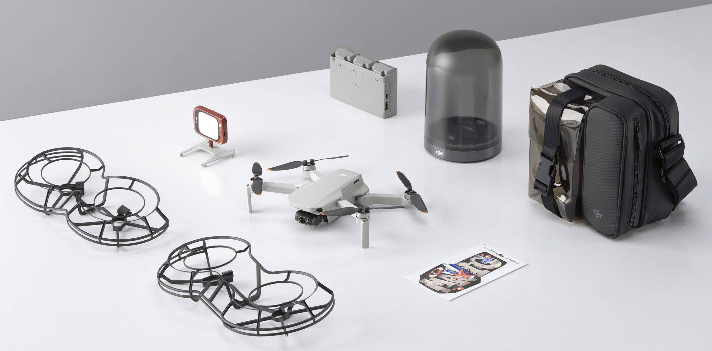 Accessories include propeller guards, the charging hub, and a charging pod that props up the Mini 2 upright — though you may not see prop guards in the US due to weight restrictions.