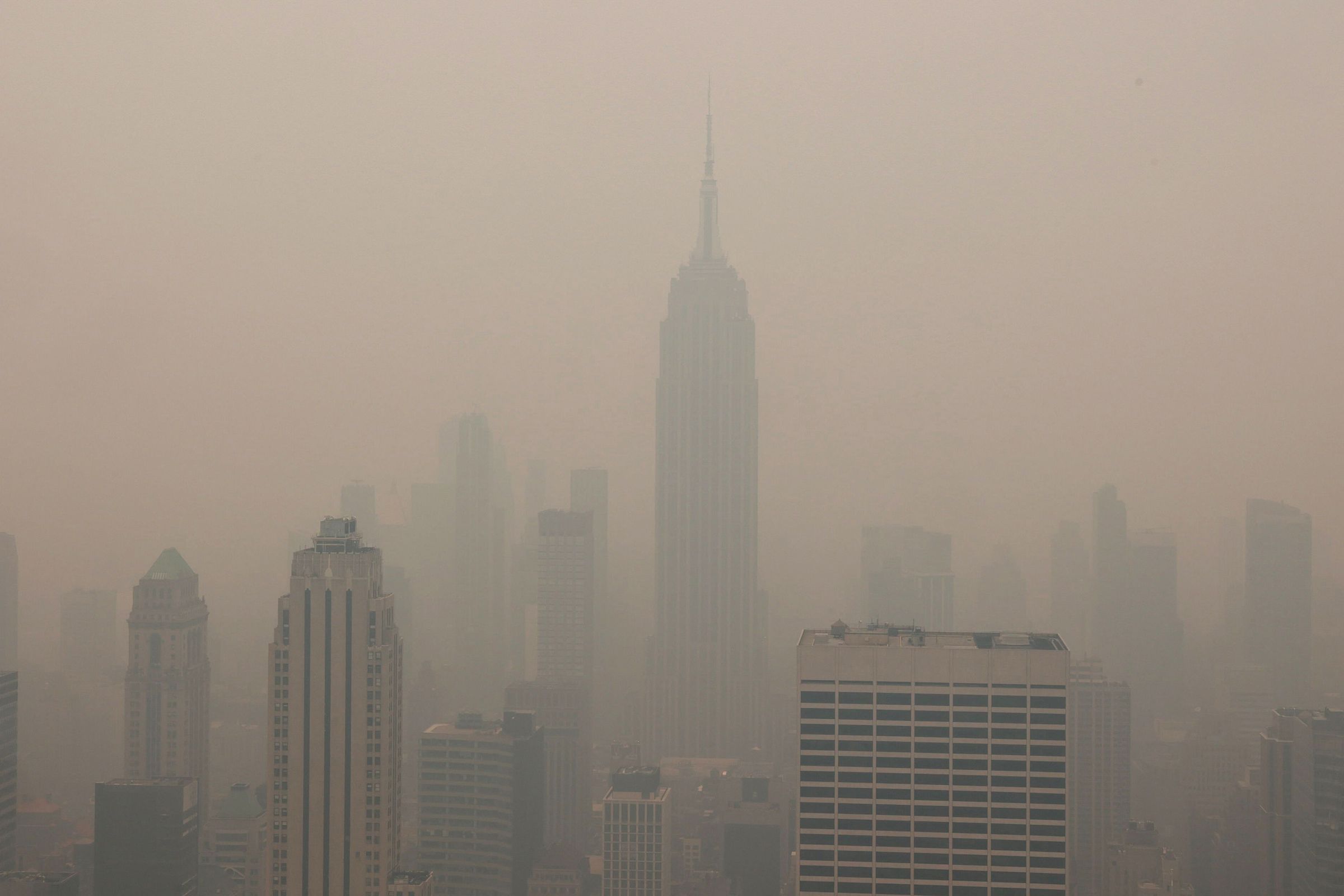 Manhattan’s skyscrapers, including the Empire State Building, are barely visible in a thick haze of smoke.