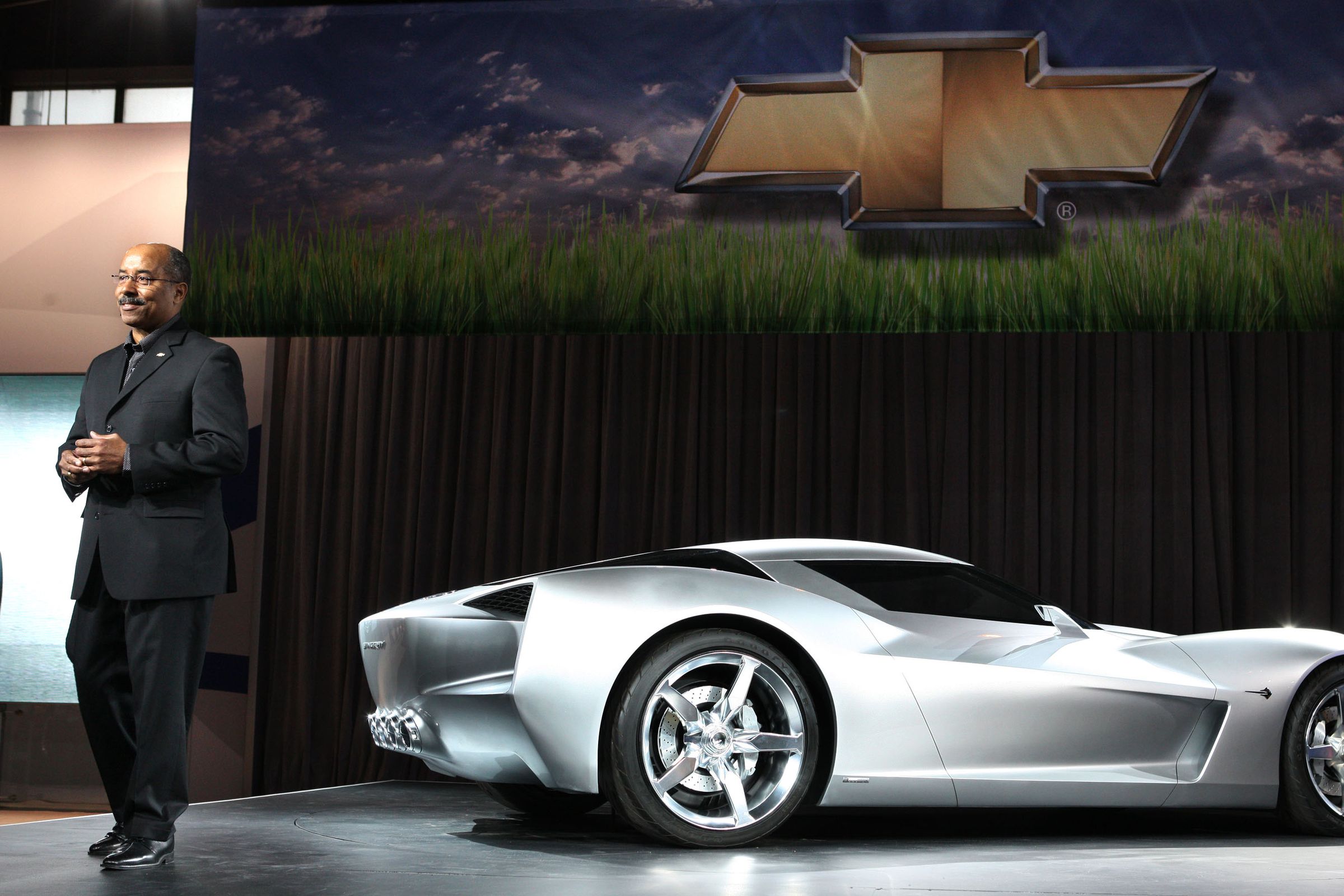 Ed Welburn standing beside the Corvette Stingray concept in 2009.
