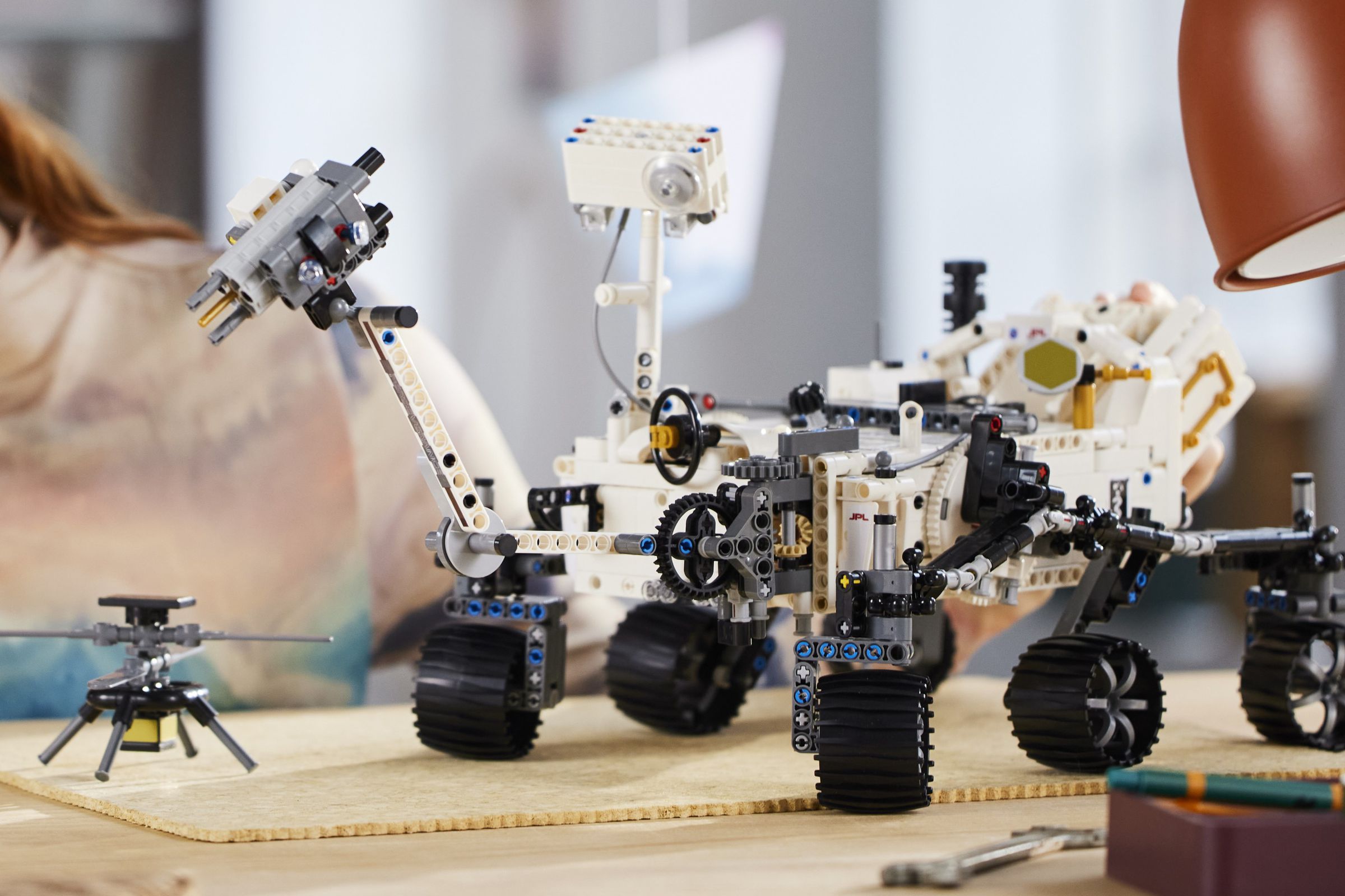 A six-wheeled Lego mars rover, with some of its wheels turning independently.