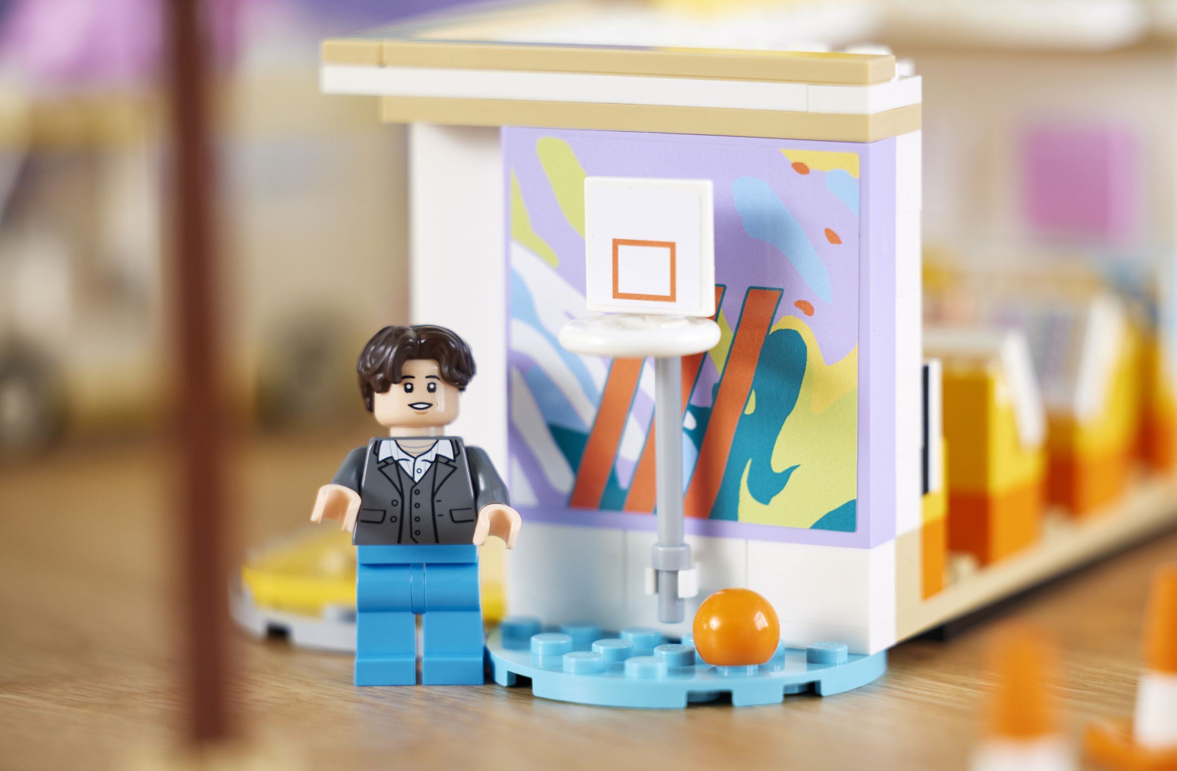 Suga Lego figurine beside a Lego basketball hoop.