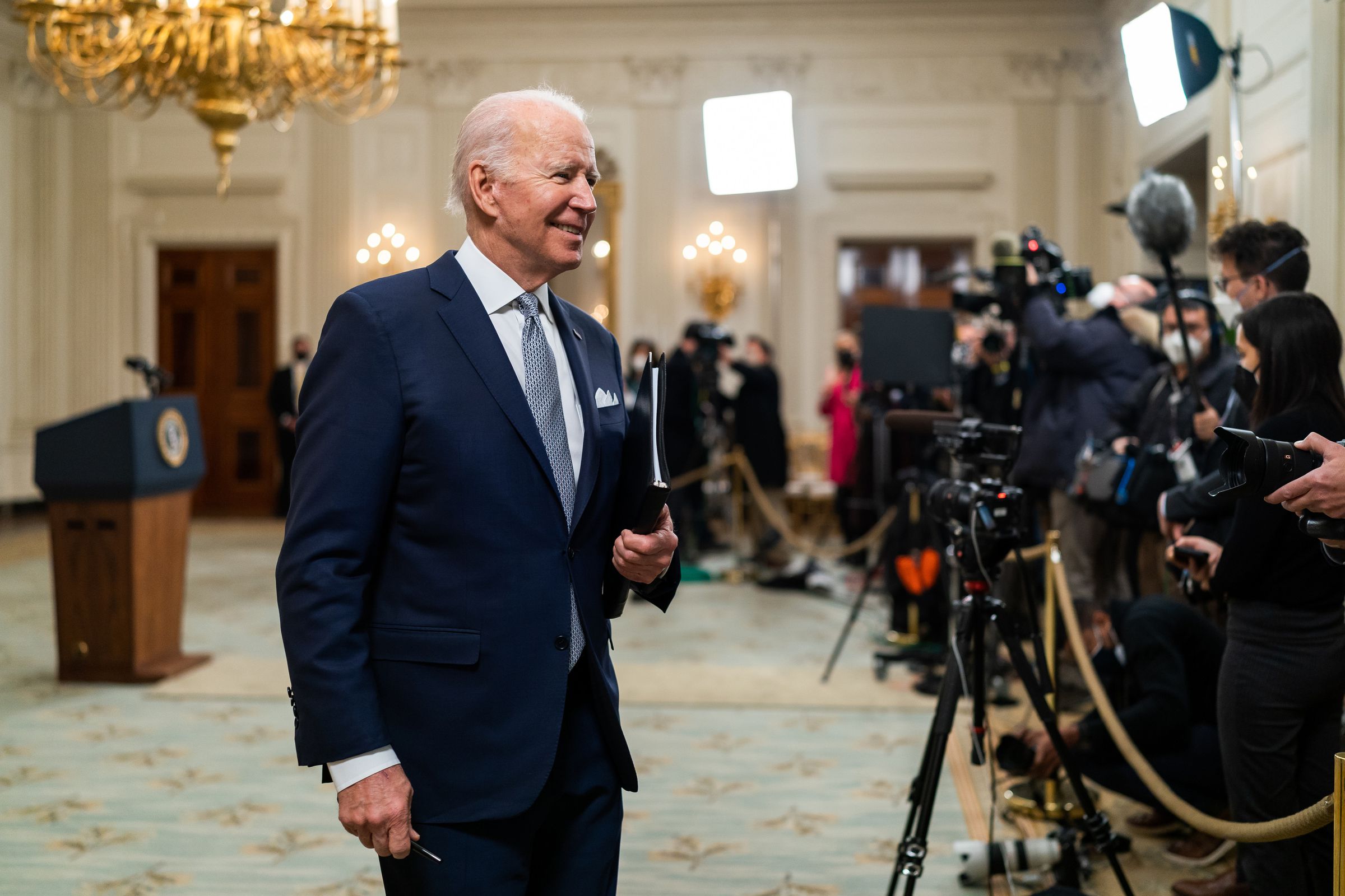 President Joe Biden smiles as he walks past members of the press after his remarks on the December jobs report, Friday, January 7, 2022, in the State Dining Room of the White House. (Official White House Photo by Cameron Smith)
