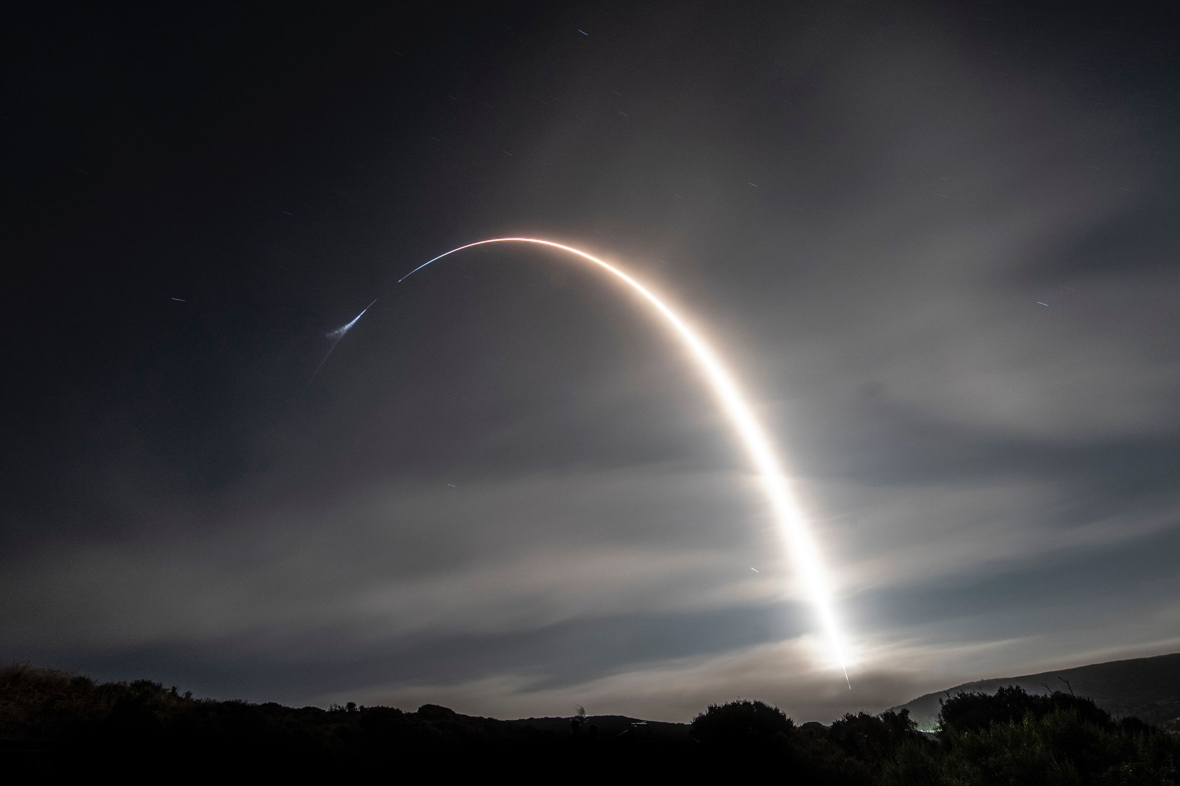 A rocket arcs into space during launch