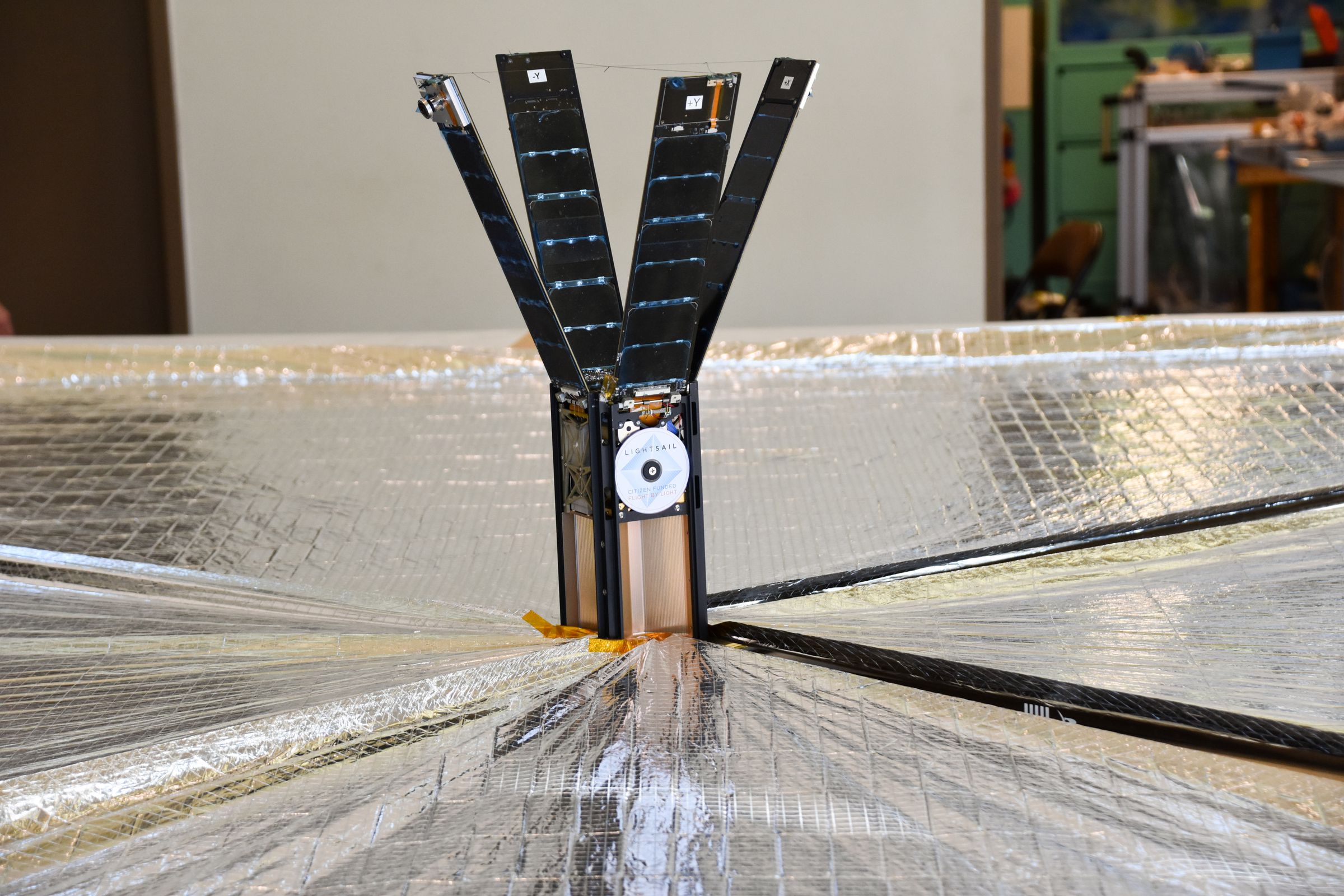 The LightSail 2 spacecraft with its solar panels and solar sail deployed.