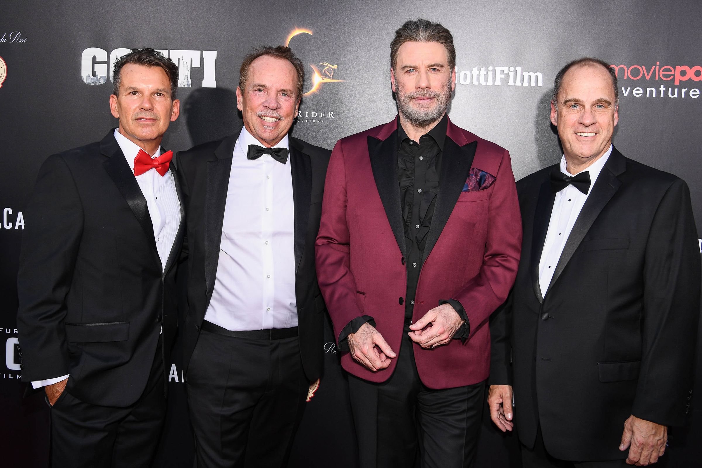 Mitch Lowe (second left) and Ted Farnsworth (right) attending the New York premiere of Gotti, a MoviePass Ventures production starring John Travolta (second right) in June of 2018. 