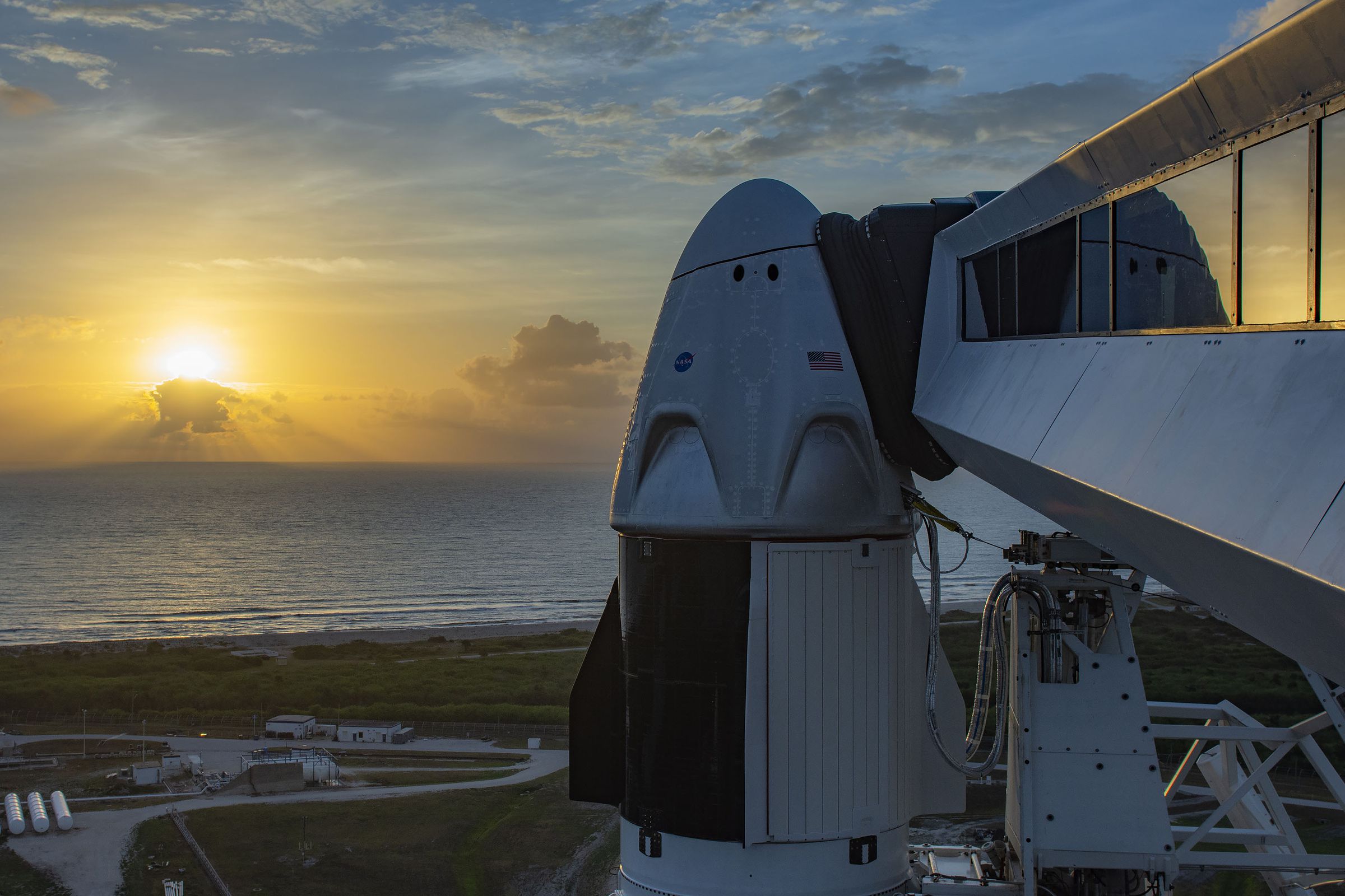 The crew access arm leading to the Crew Dragon, perched atop the Falcon 9.