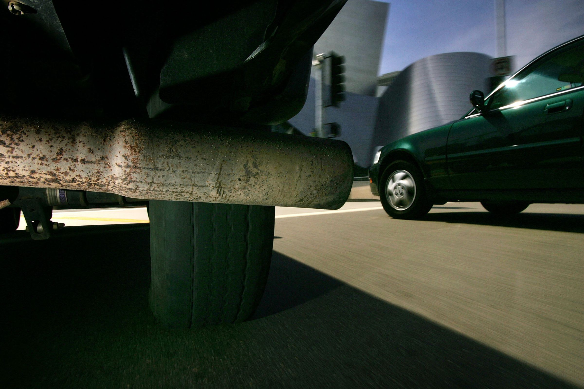 The tailpipe of a vehicle pumping out greenhouse gas emissions is seen next to another car in Los Angeles, CA.