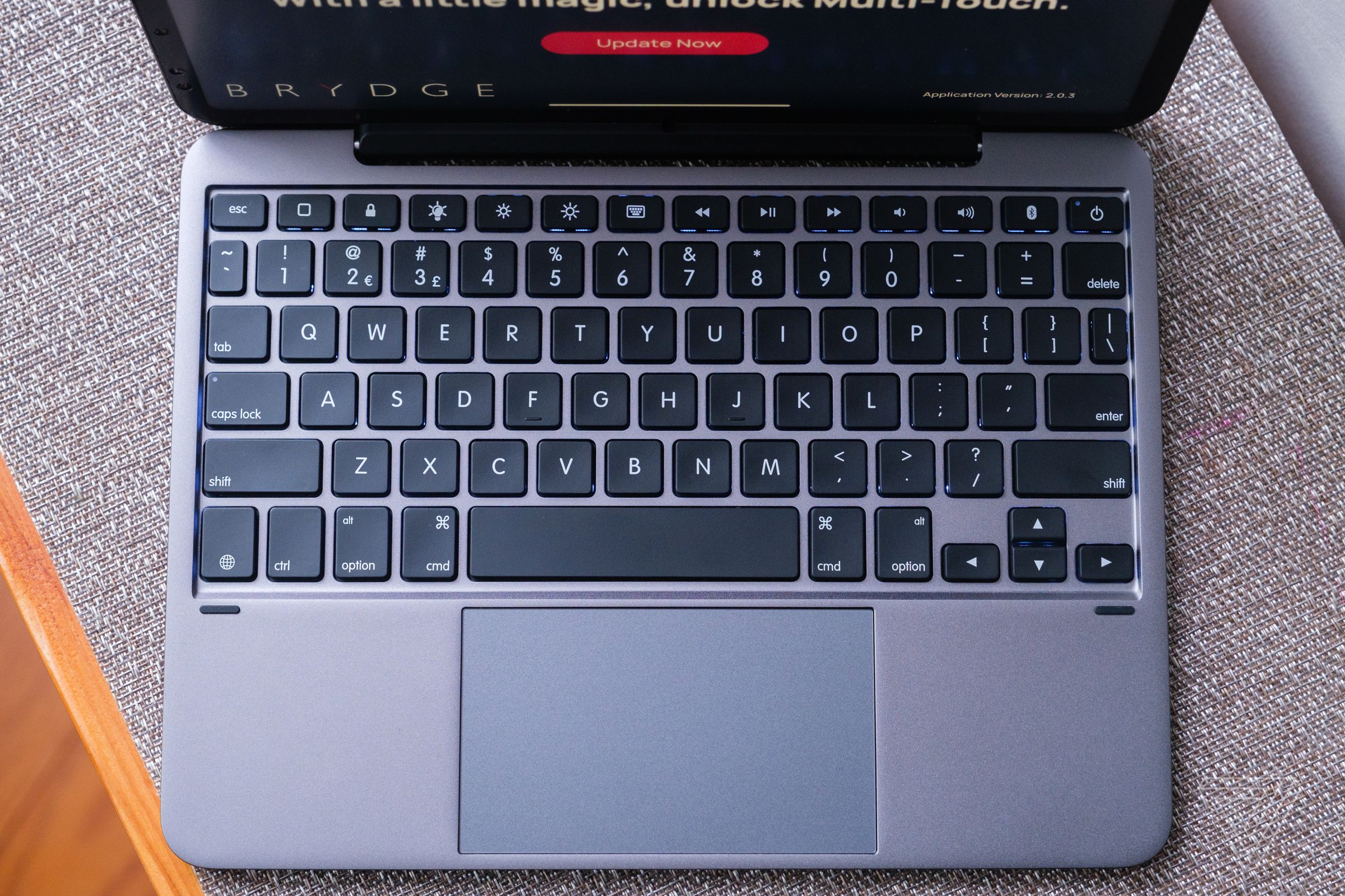 The 11 Max Plus has a full keyboard with function row and a large multitouch trackpad.