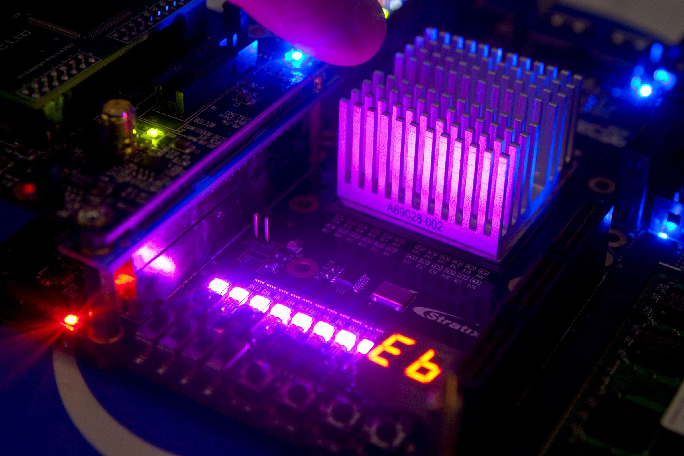 An Intel researcher points to the heat sink of a programmabl
