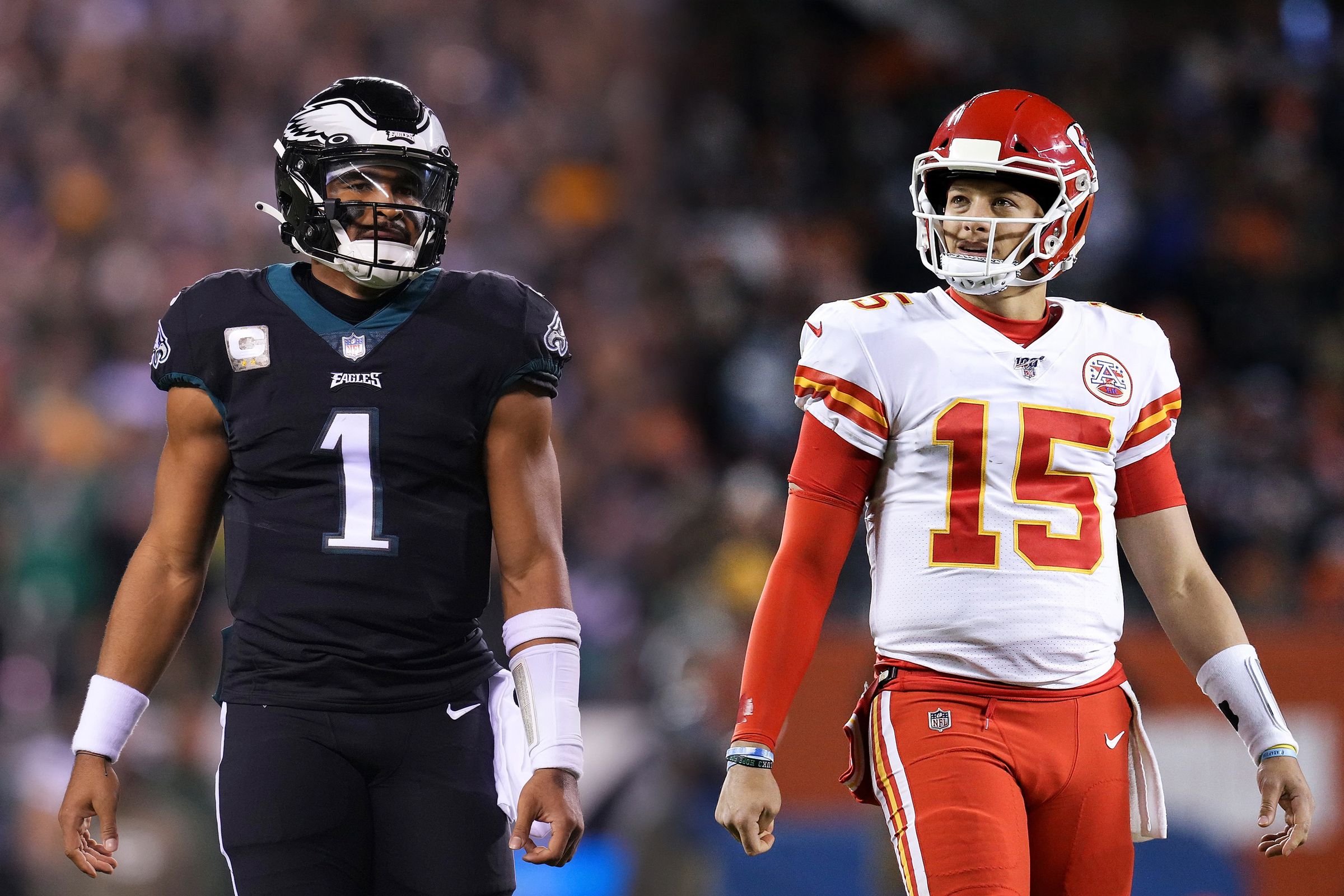 Eagles quarterback Jalen Hurts and Chiefs quarterback Patrick Mahomes are standing in football uniform with a blurry stadium audience in the background.