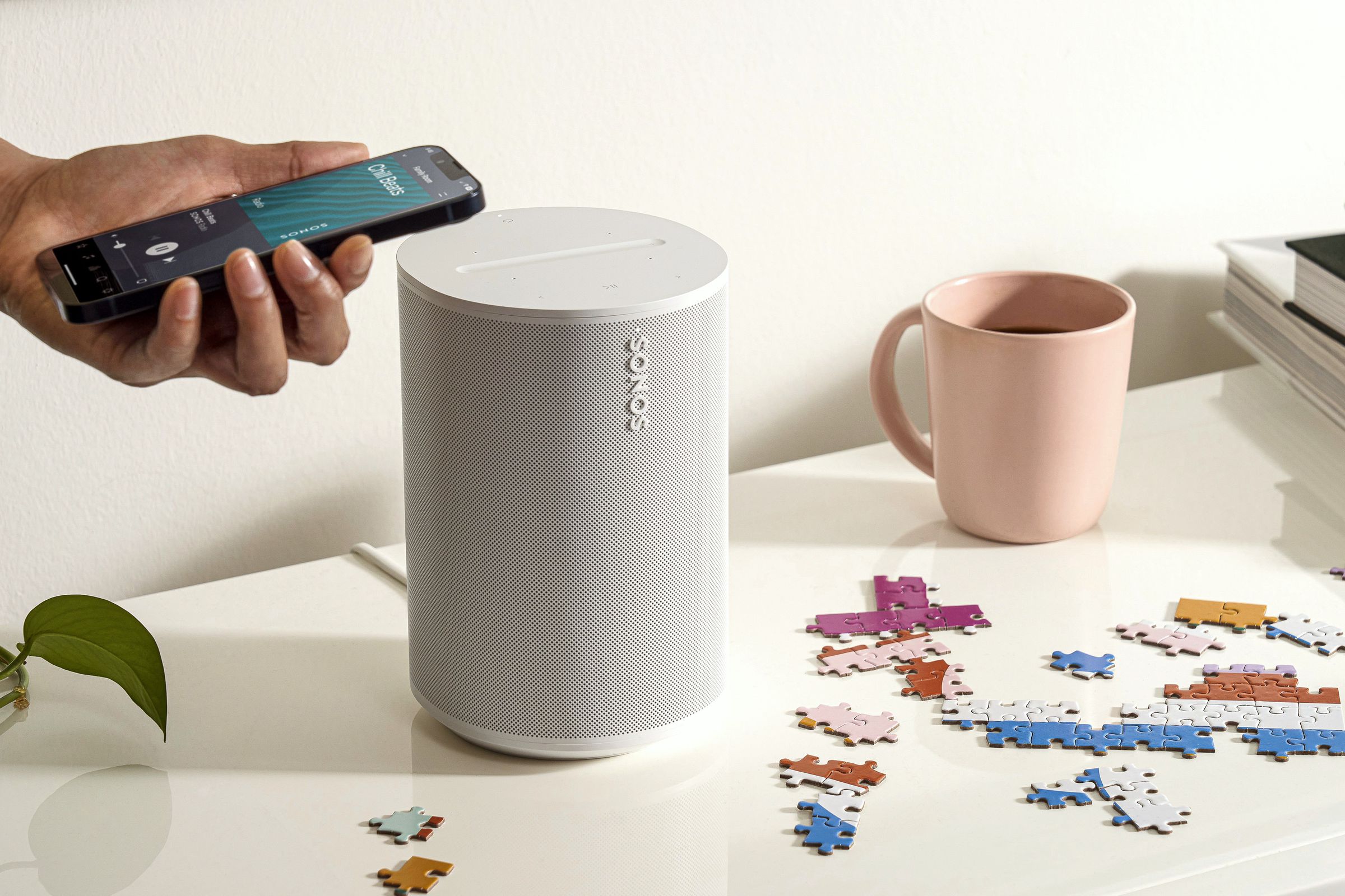 A marketing image of the Sonos Era 100 on a white table.
